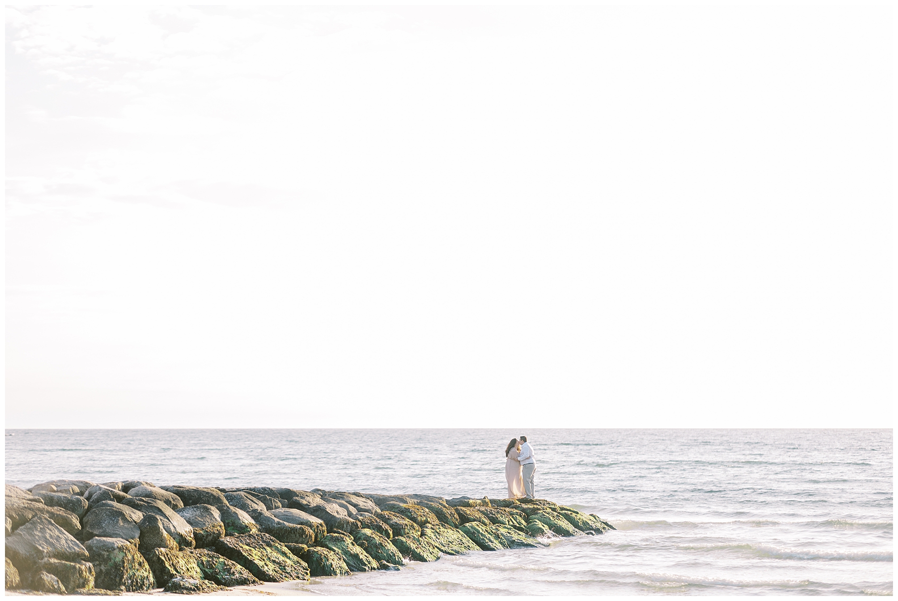 Couple on rocky shoreline in Cape Cod