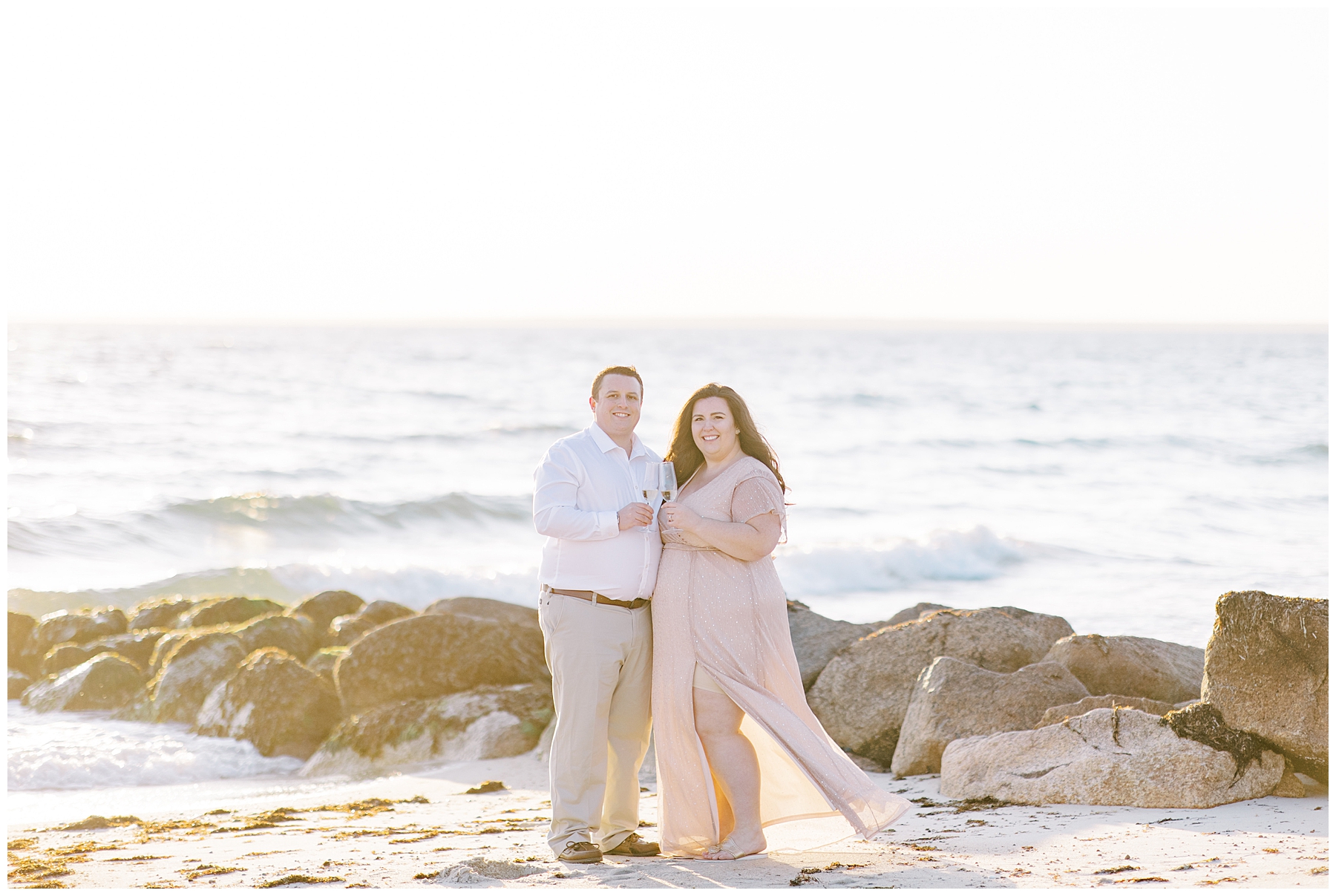 newly engaged couple celebrate on the beach during engagement session
