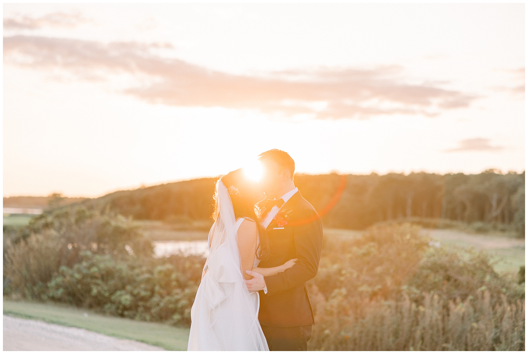 sunset shines in the background of newlywed portraits 