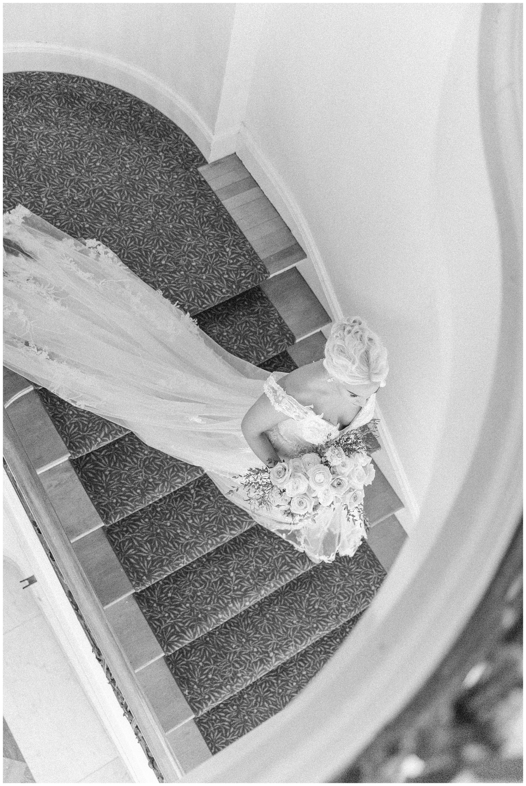 aerial photo of bride walking down stairs 