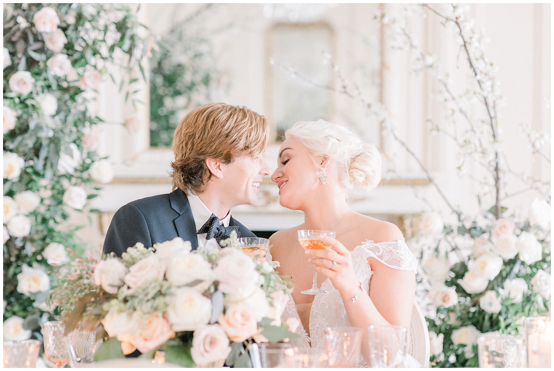 couple kiss at head table during Tupper Manor Wedding 