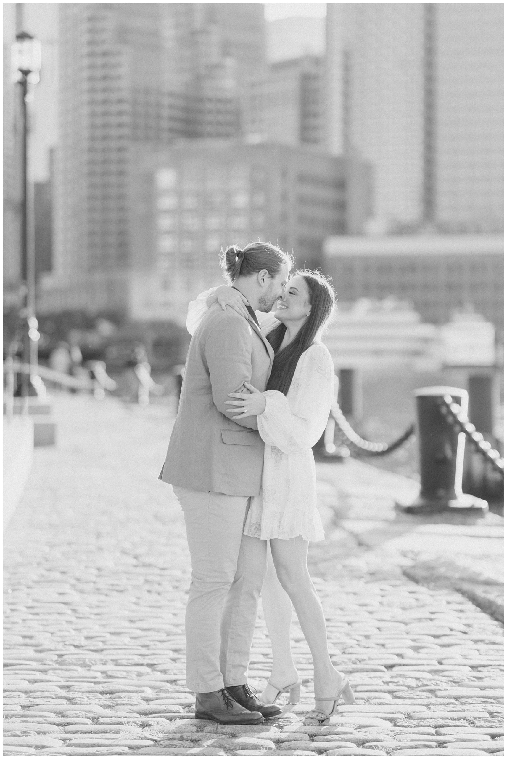 couple lean in to kiss during Downtown Boston Engagement Session