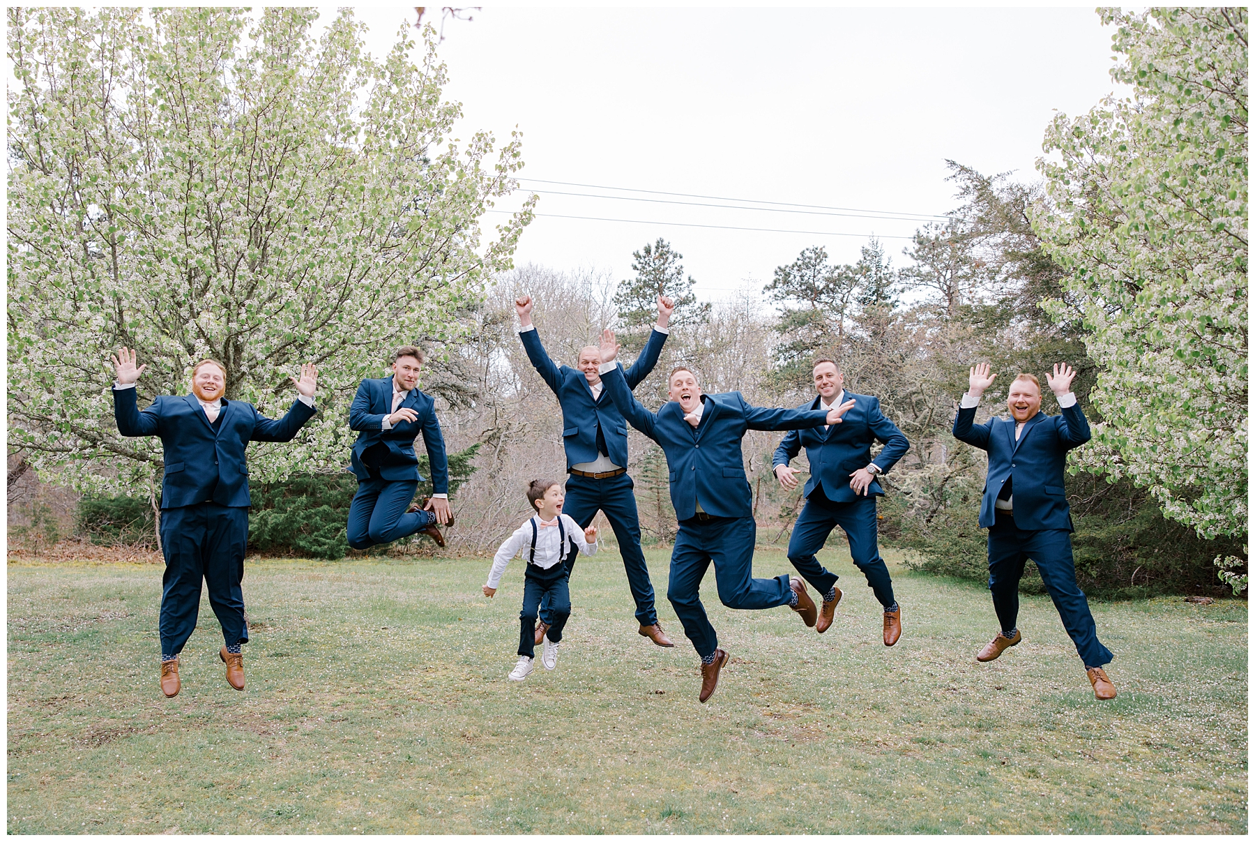 groom and groomsmen jump up for for fun photo