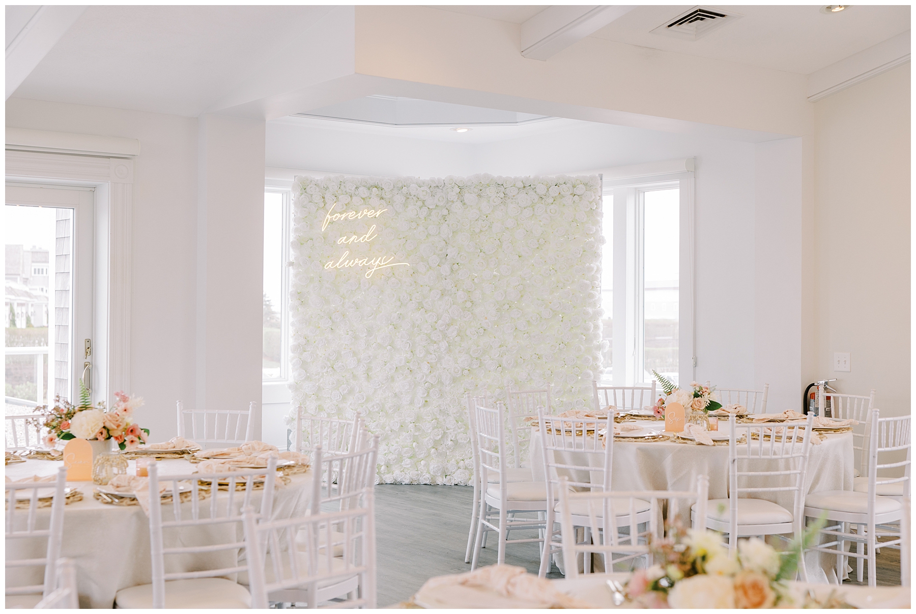 white flower photo wall at wedding 