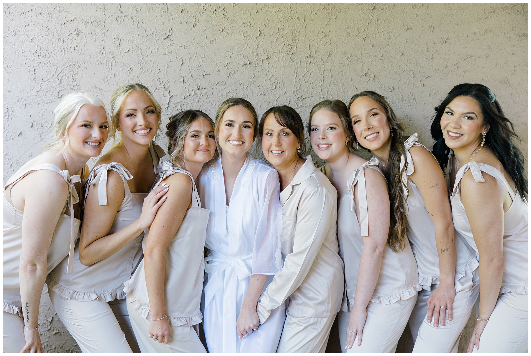 bride and bridesmaids in matching outfits 