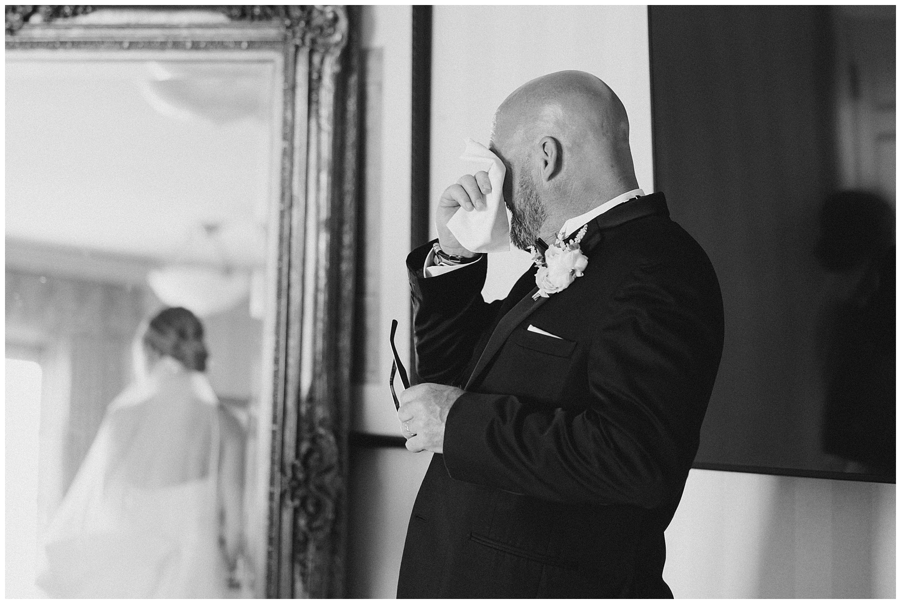father wipes away tears during first look with daughter on wedding day