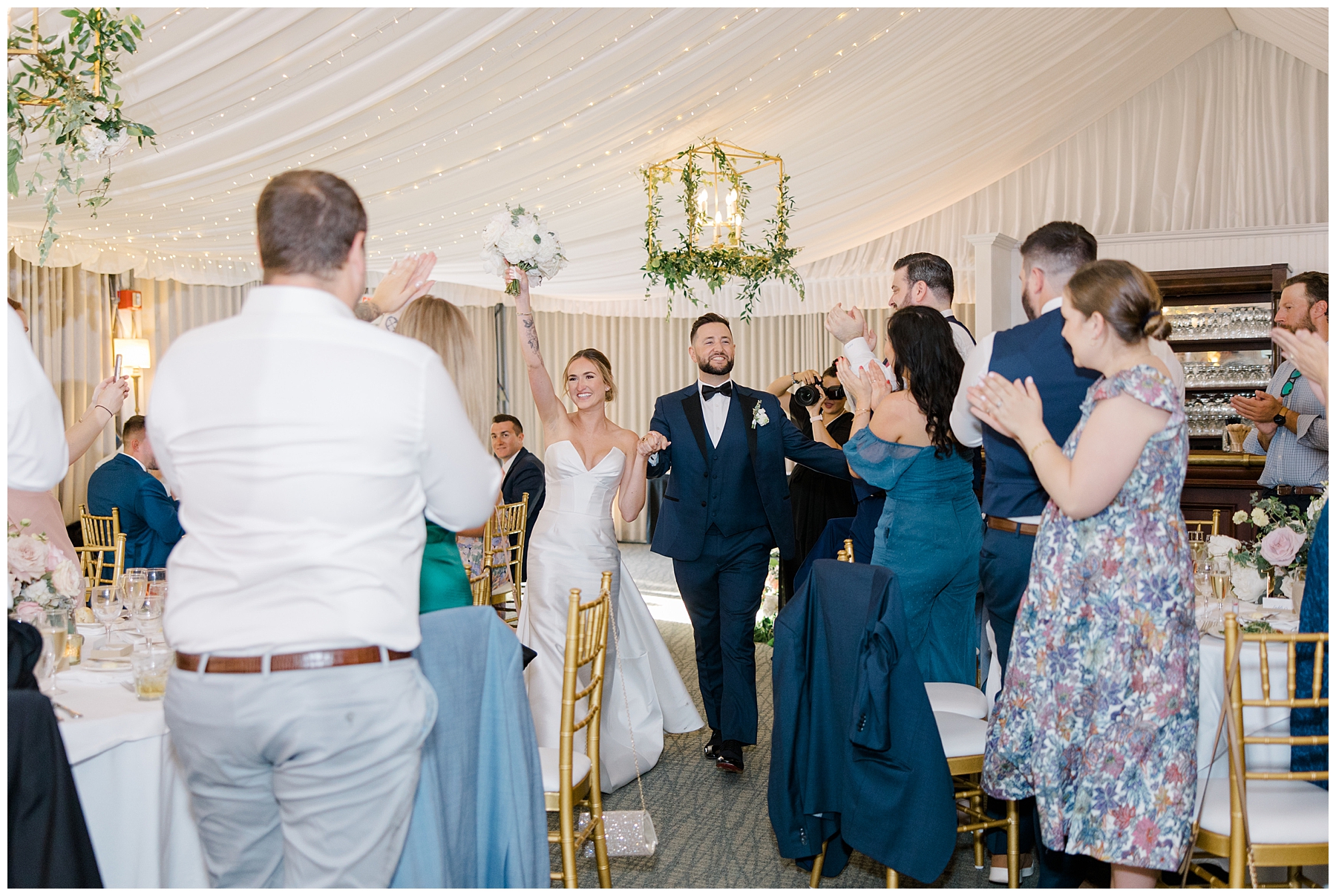 guests clap as bride and groom enter reception 