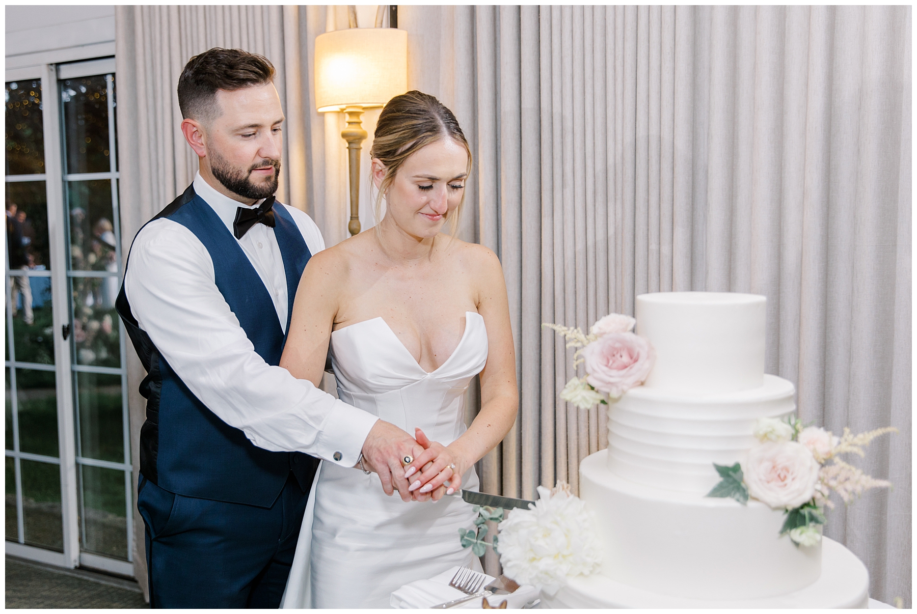 bride and groom cut into wedding cake 