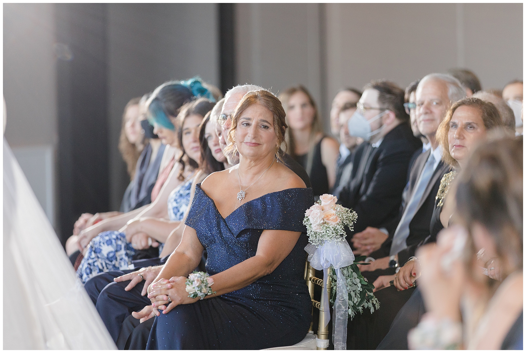 mom is emotional seeing bride walk down the aisle  