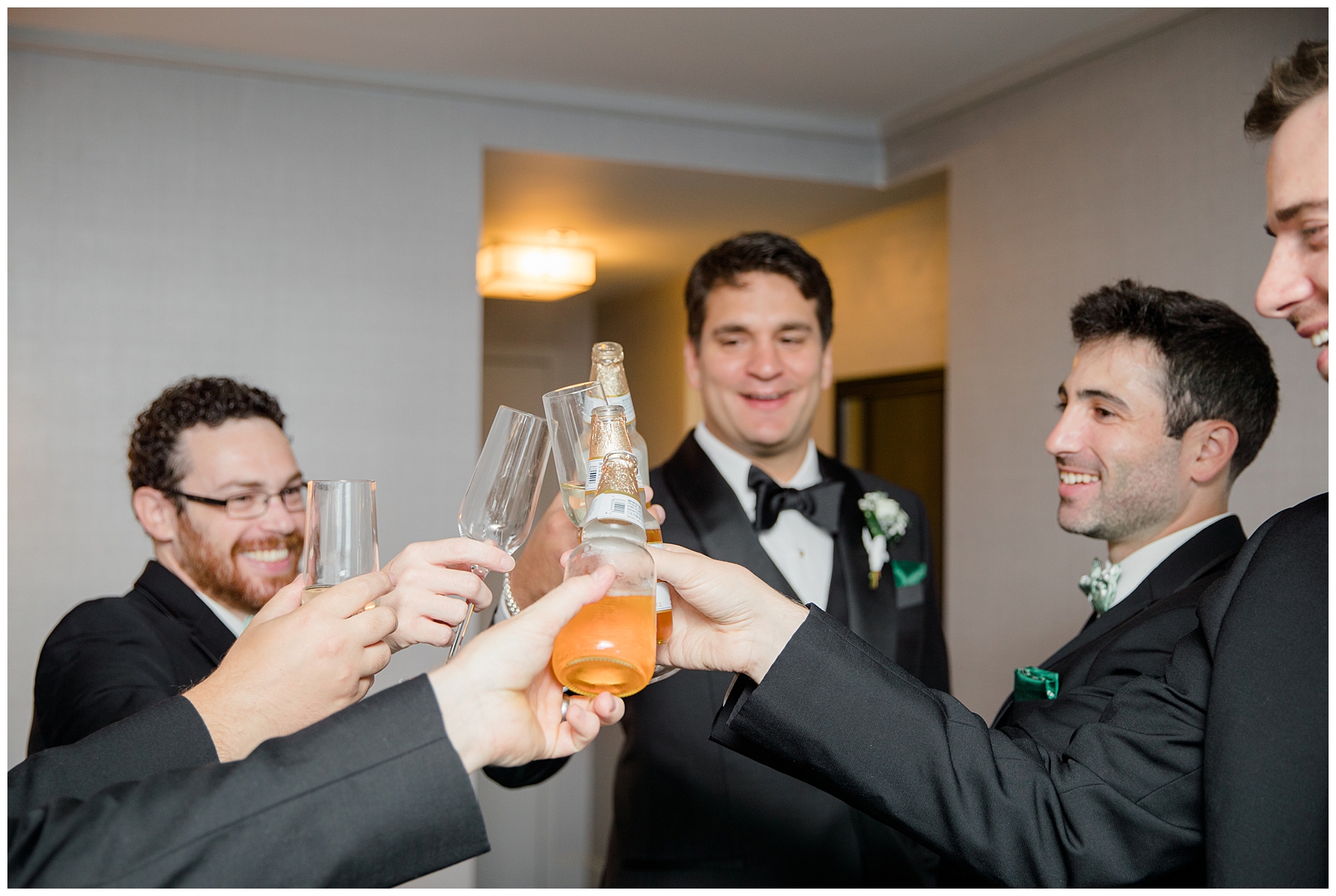 groom and groomsmen cheers before wedding ceremony wedding at The Royal Sonesta in Boston 