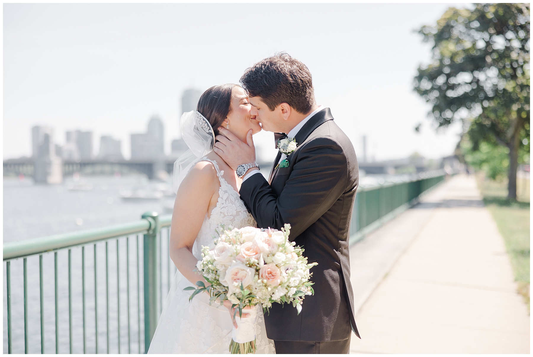 couple kiss before Glamorous Royal Sonesta Wedding in Boston 