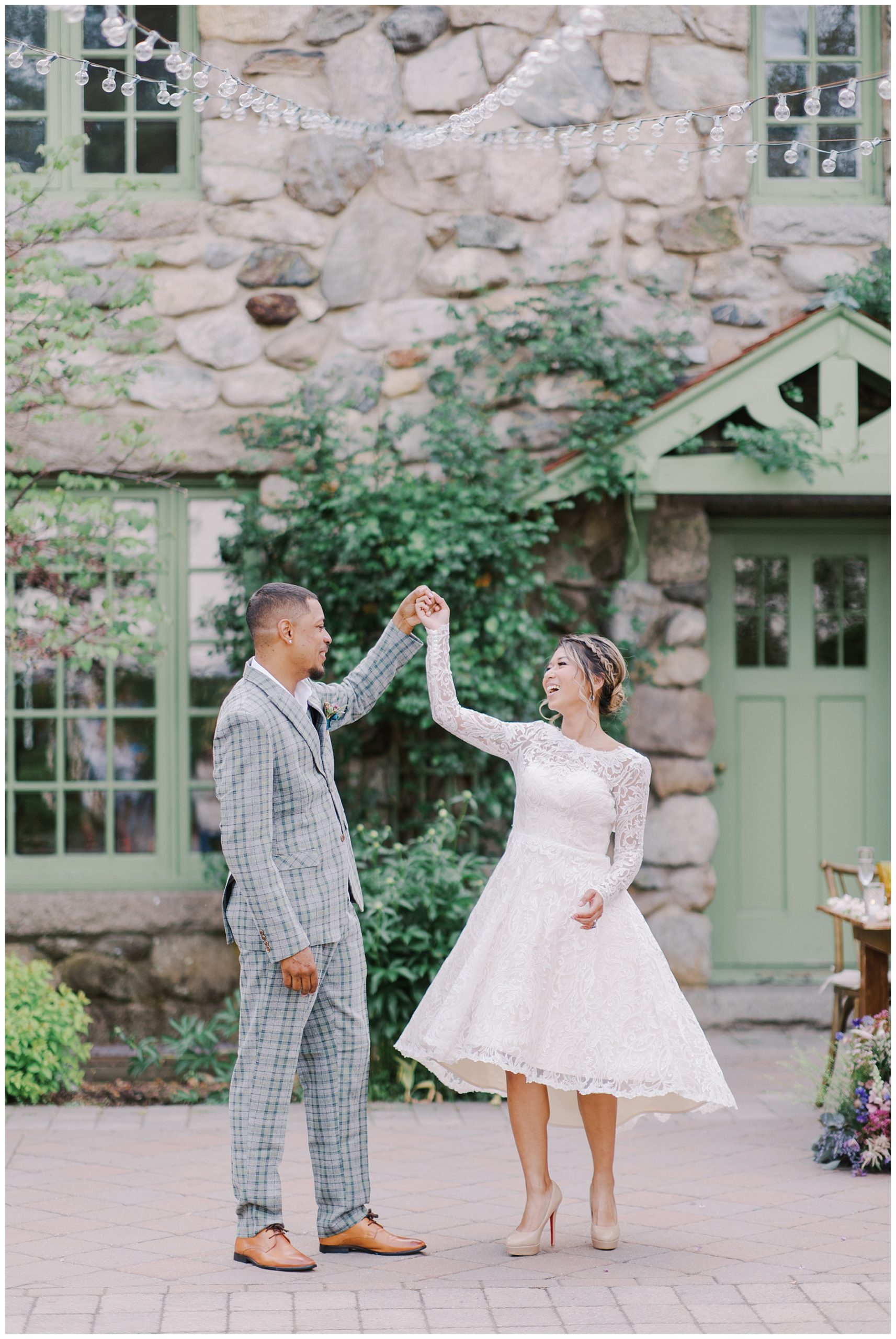 newlyweds dance on outdoor patio at Willowdale Estate Wedding