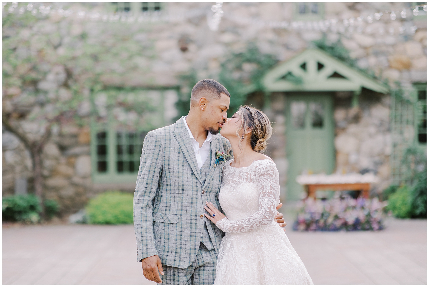 newlyweds kiss on the grounds of Willowdale Estate