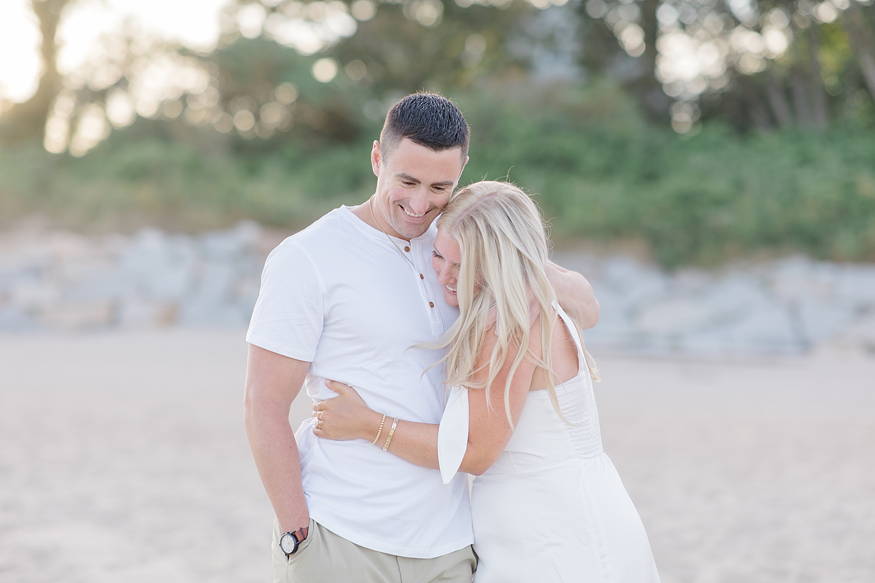 candid moment of couple during engagement portraits on MA beach