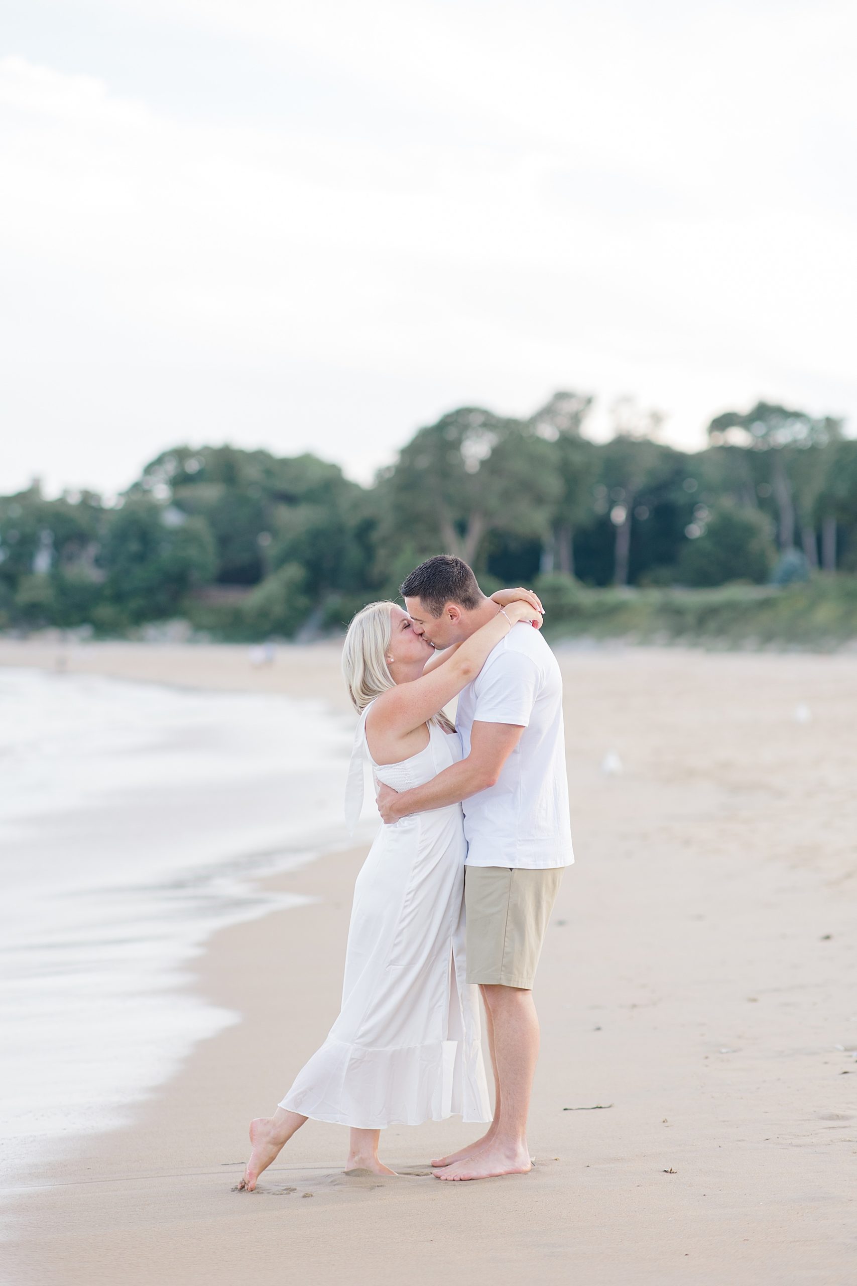 couple kiss during Timeless Beach Engagement 