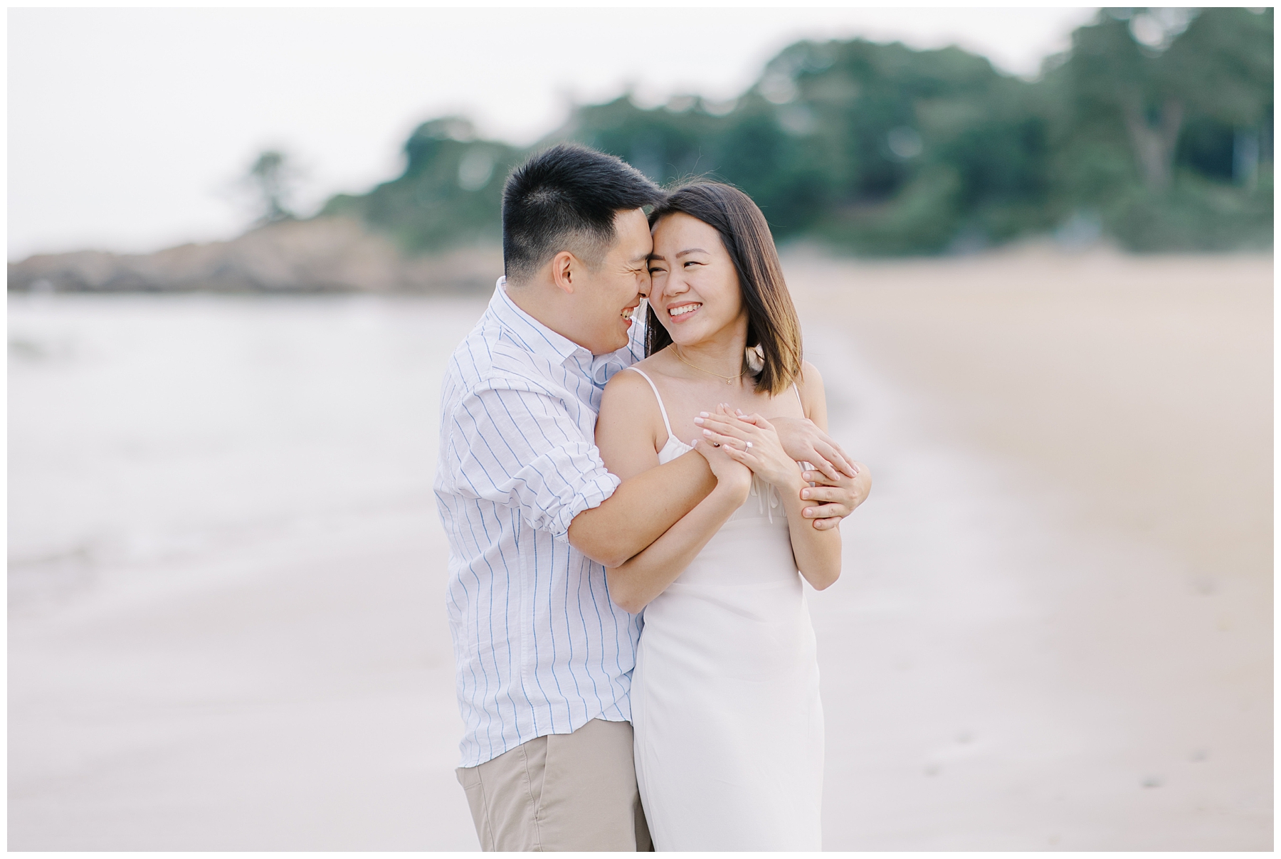 couple smile at each other during engagement portraits