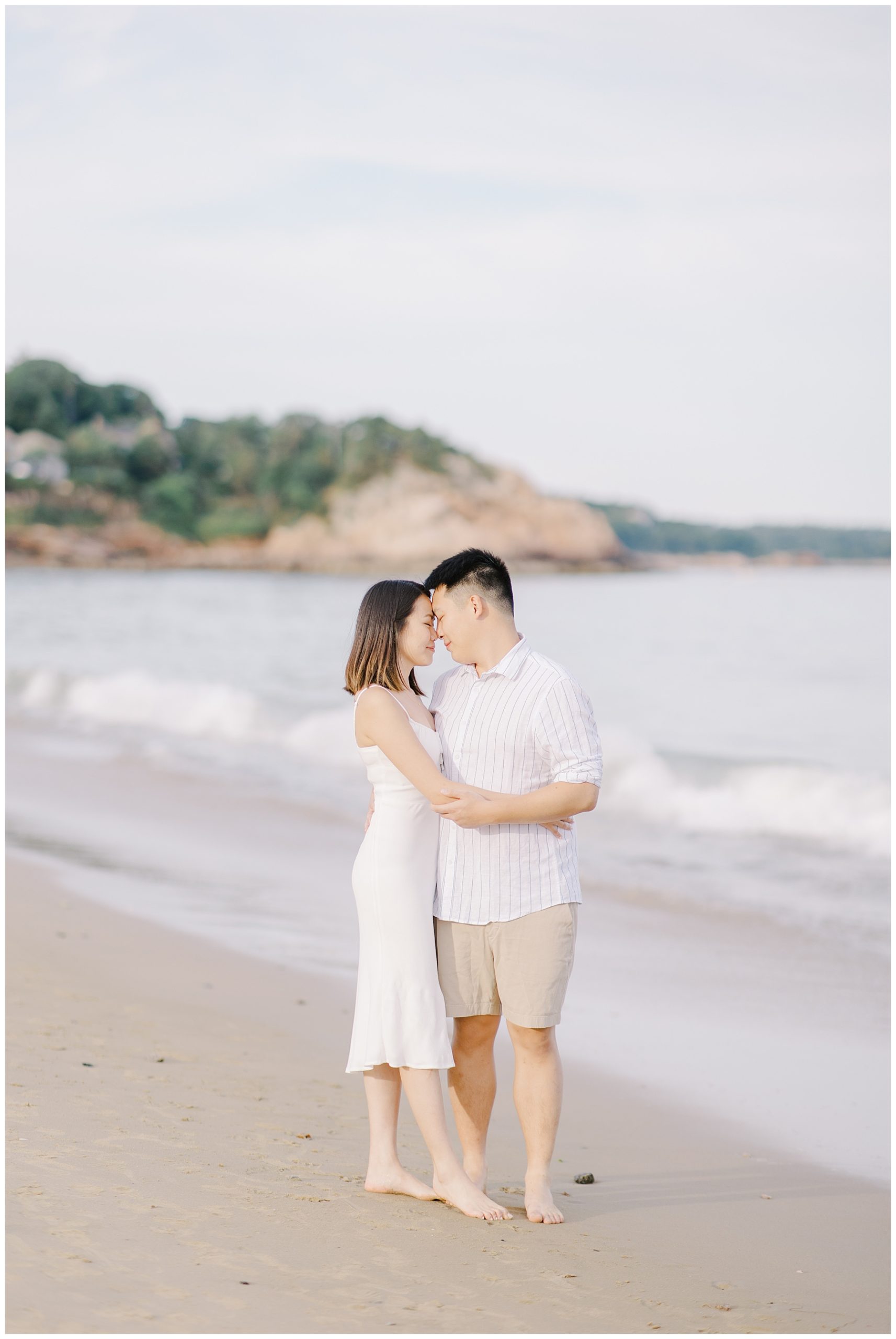 couple lean in together during engagement portraits 