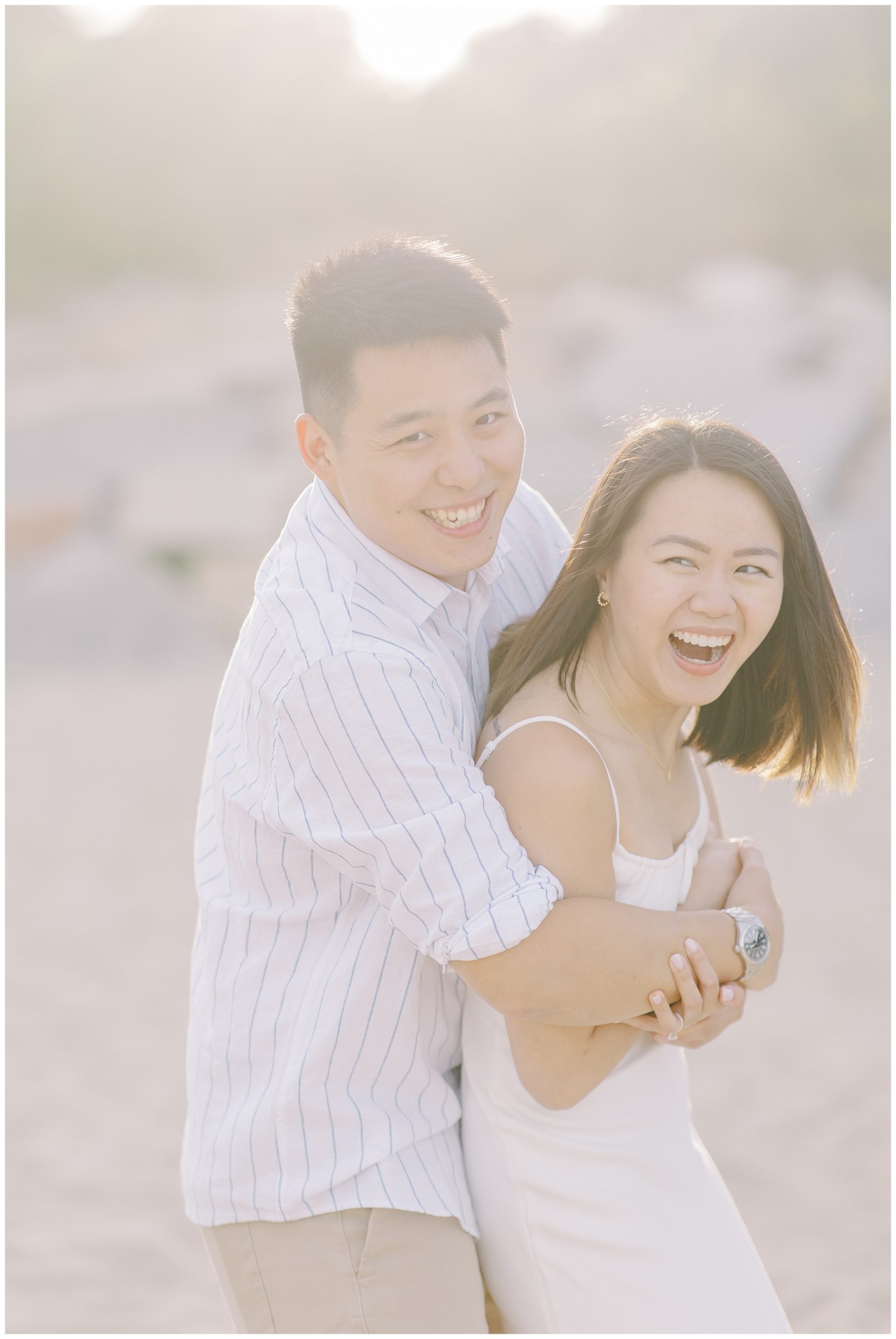 couple shares laughter during Romantic Beach Engagement Session in Beverly, MA