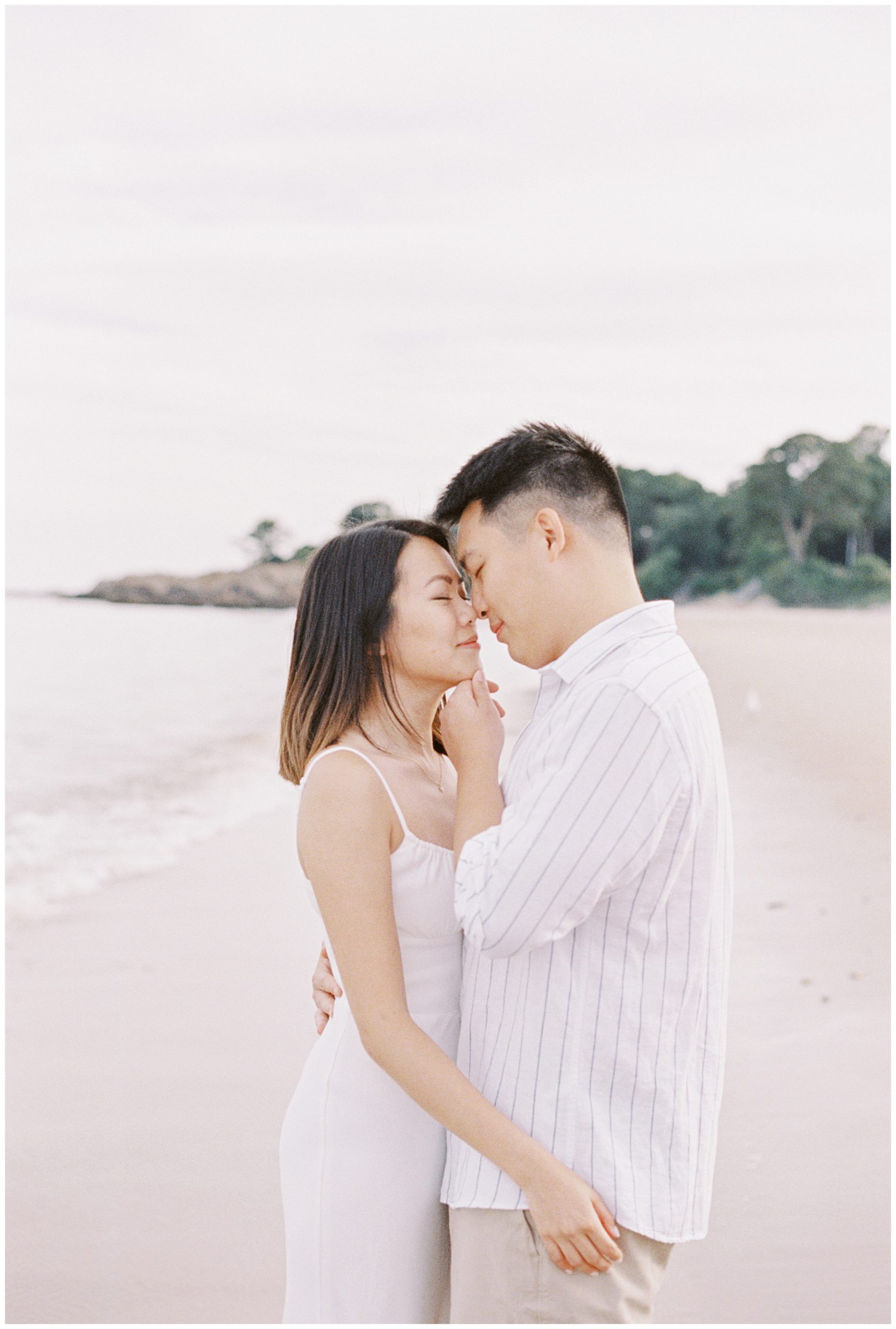 couple kiss during Romantic Beach Engagement Session in Beverly, MA