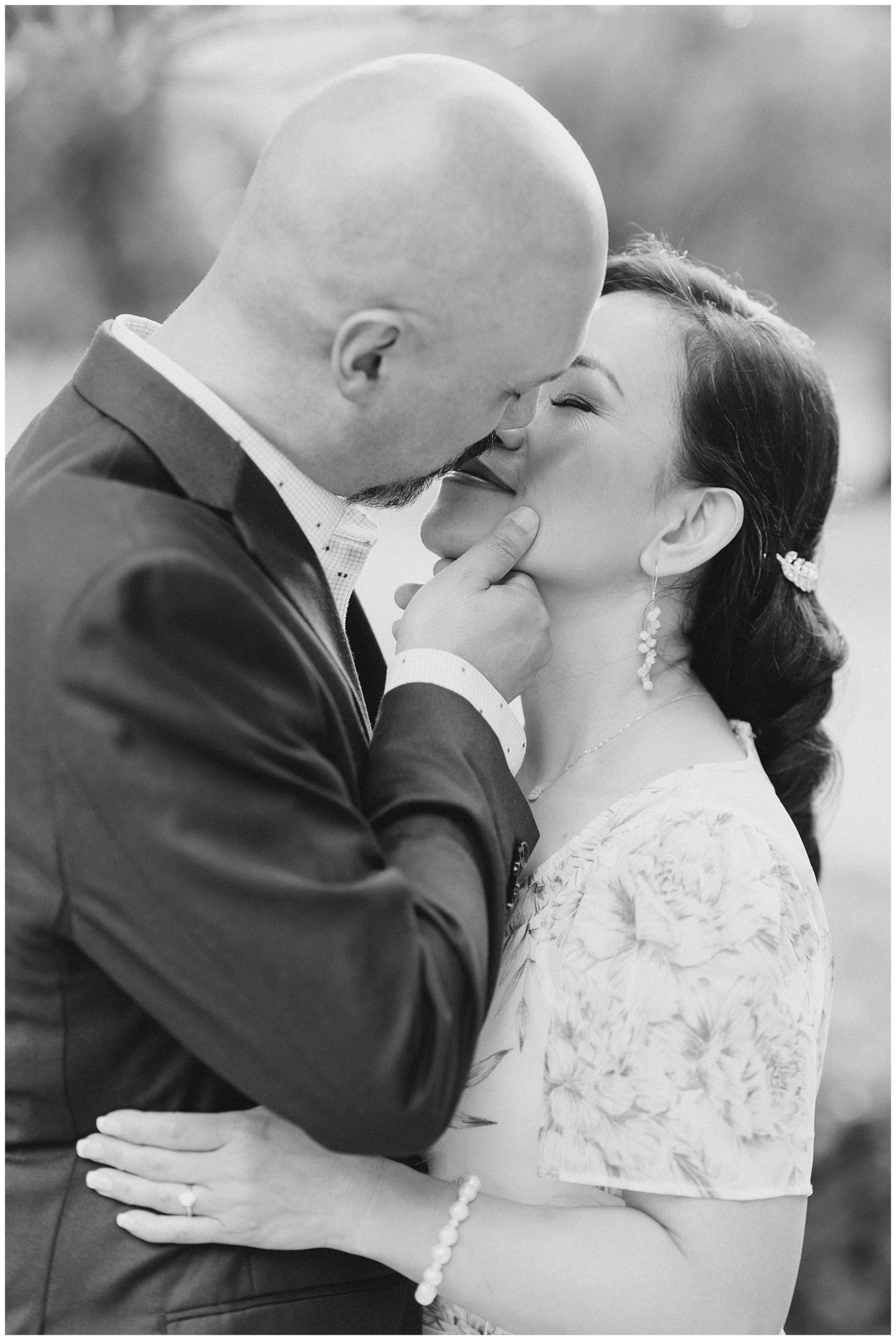 couple steal a kiss during intimate moment of engagement session
