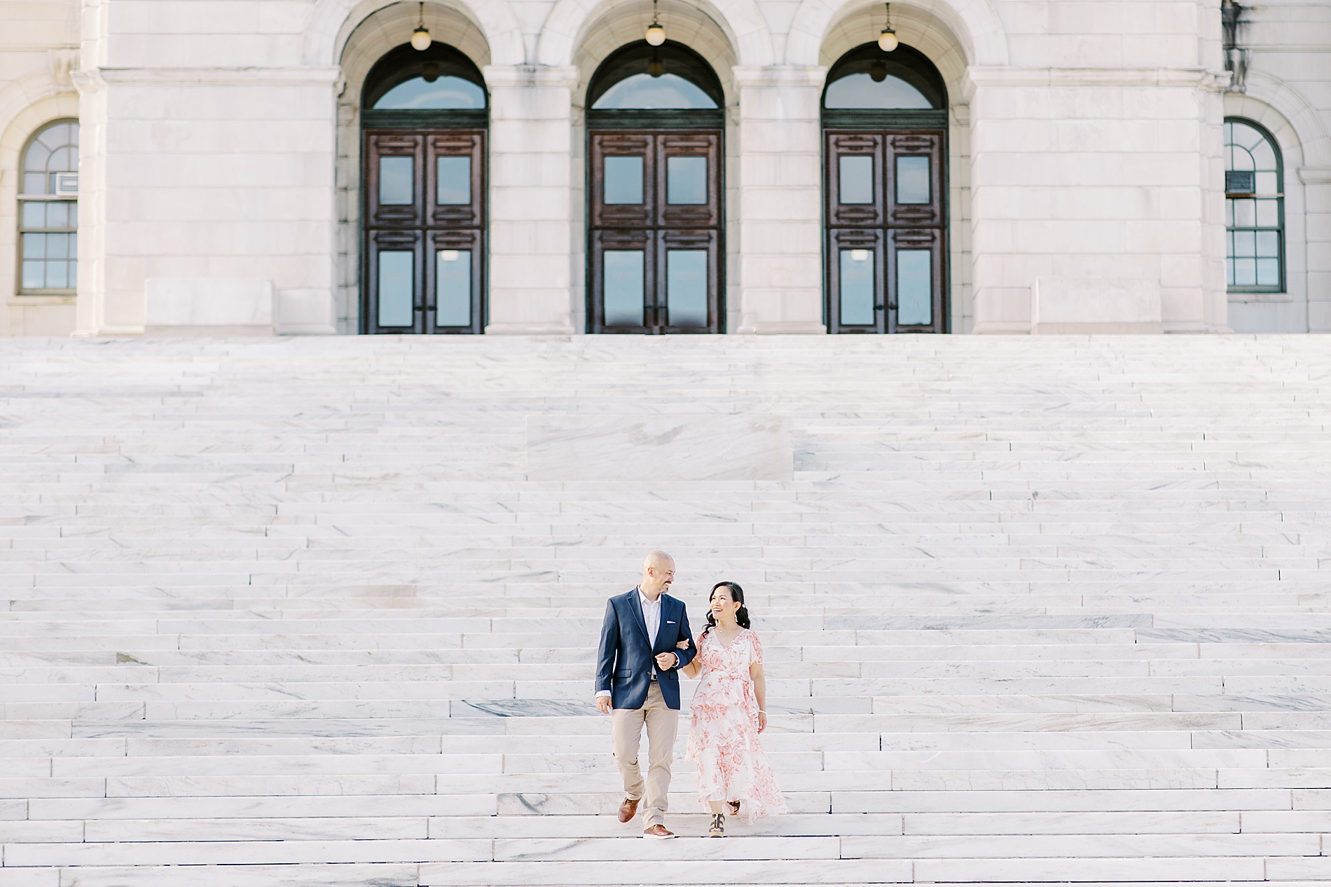 couple walking down the steps during Rhode Island Engagement Session
