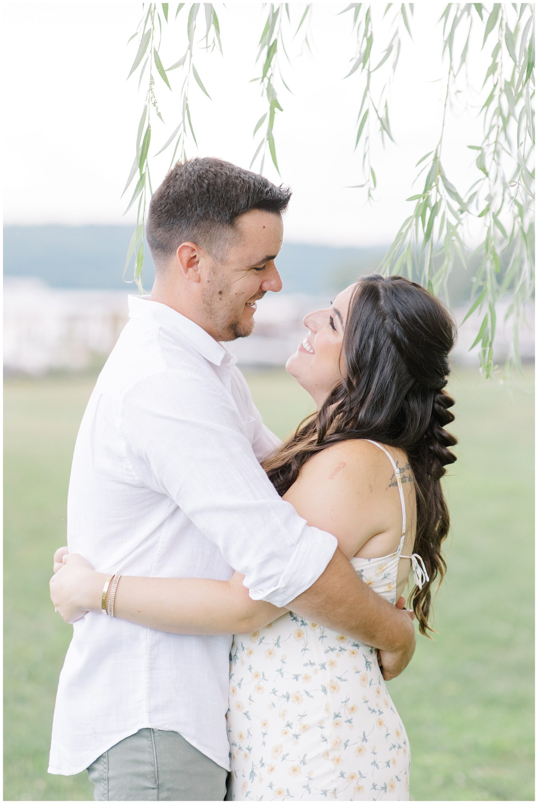 newly engaged couple look at each other during romantic engagement portraits 
