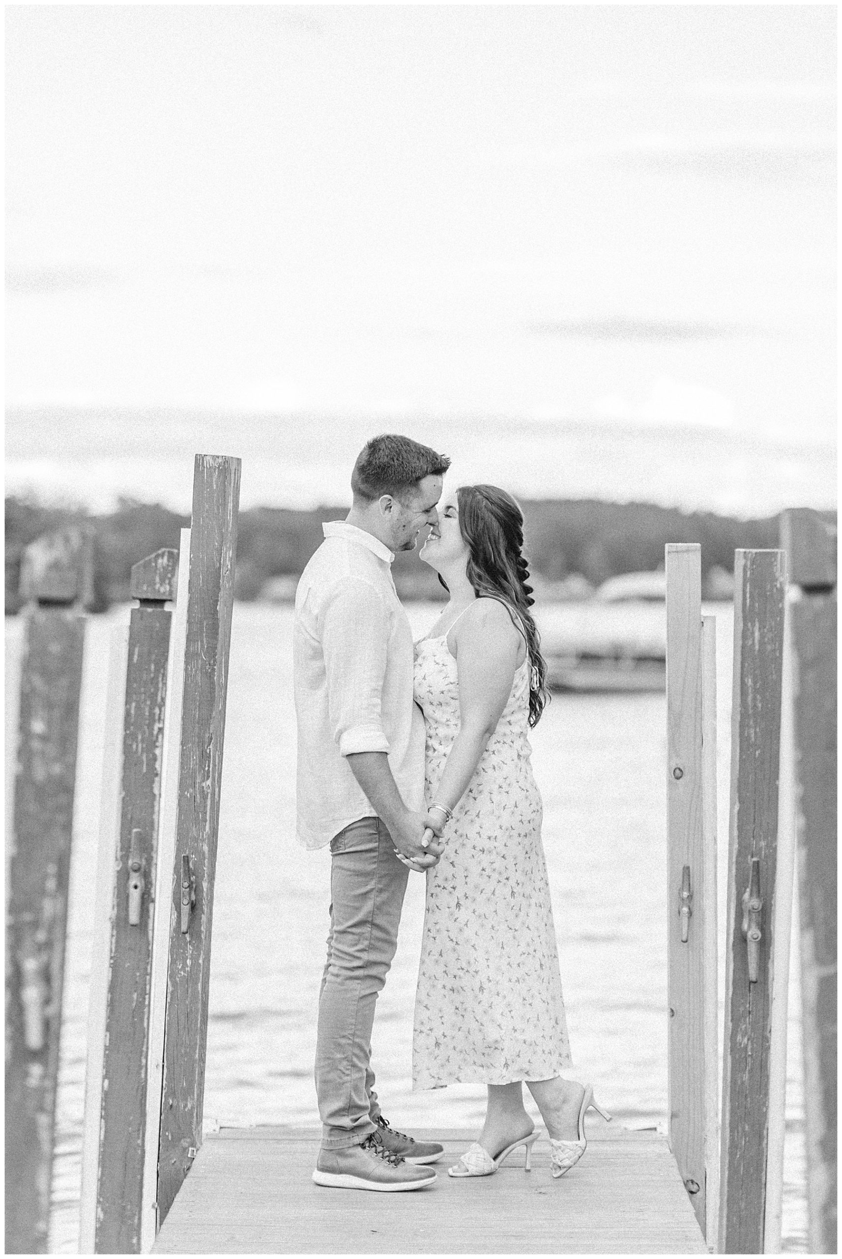 couple kiss on boat docks at Lake Winnipesaukee, NH 