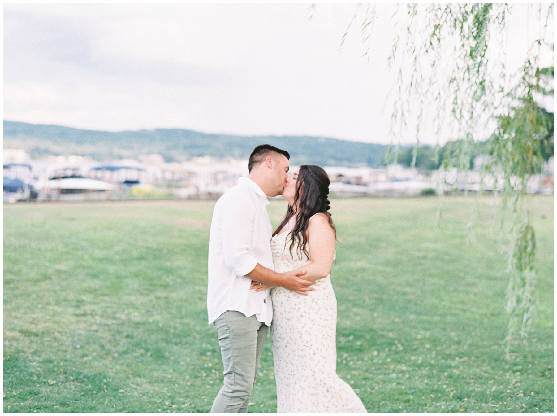 couple kiss during Lake Winnipesaukee, NH Engagement Session 