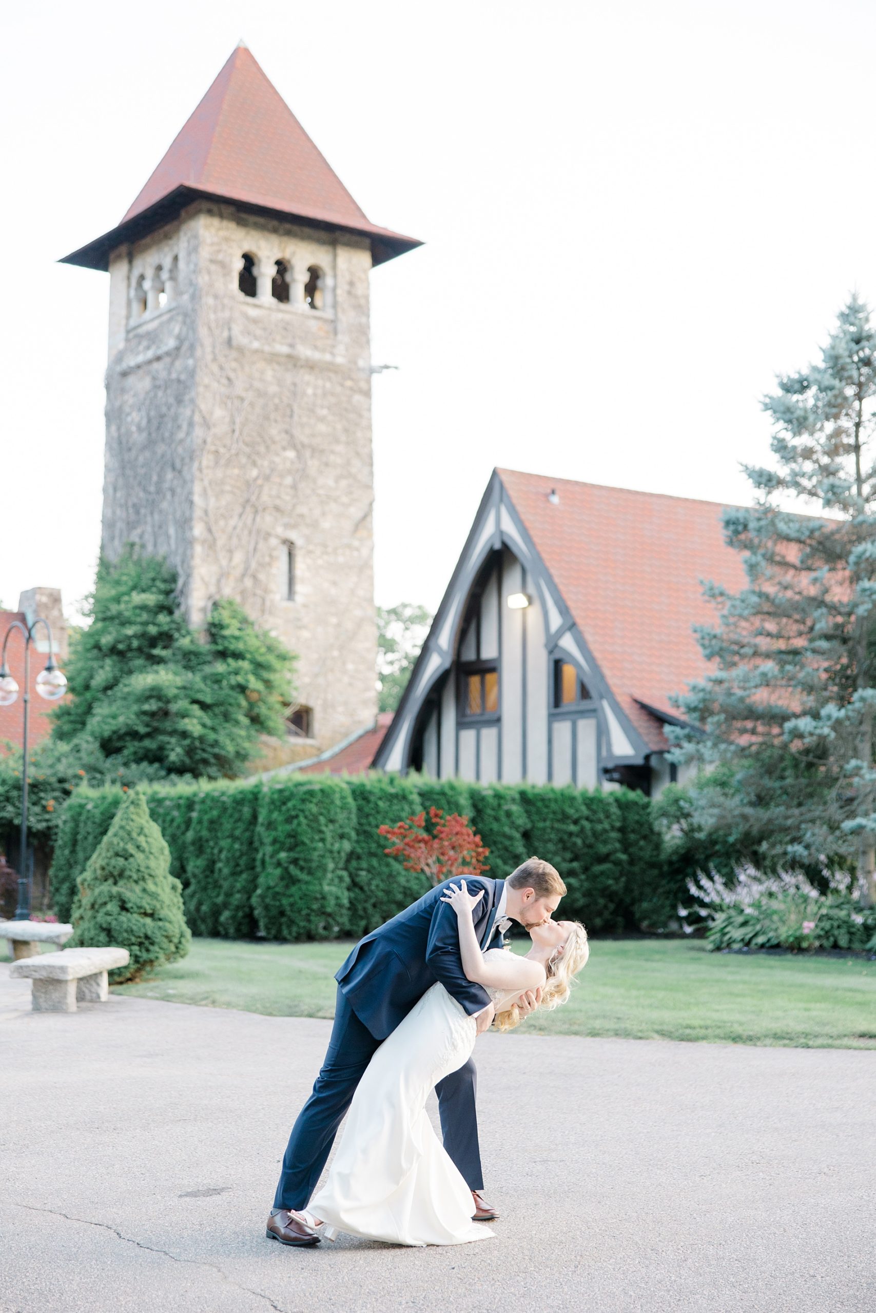 newlyweds kiss in front Saint Clements Castle after Fairytale Wedding