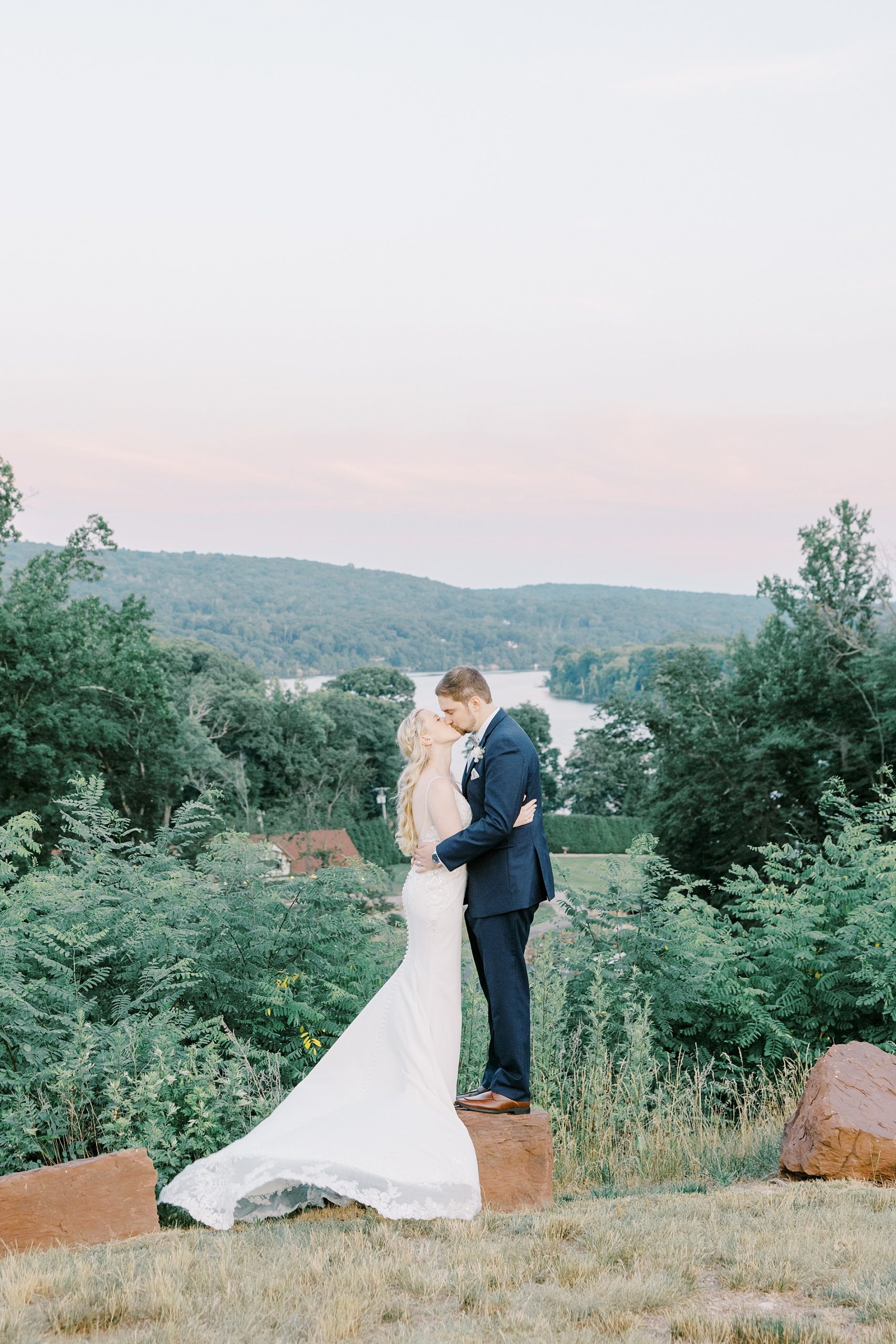couple kiss on hilltop overlooking the Connecticut river 