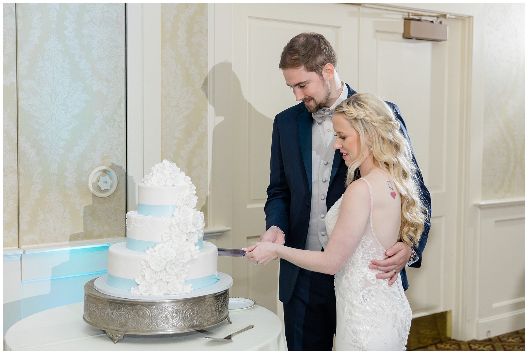 bride and groom cut into wedding cake