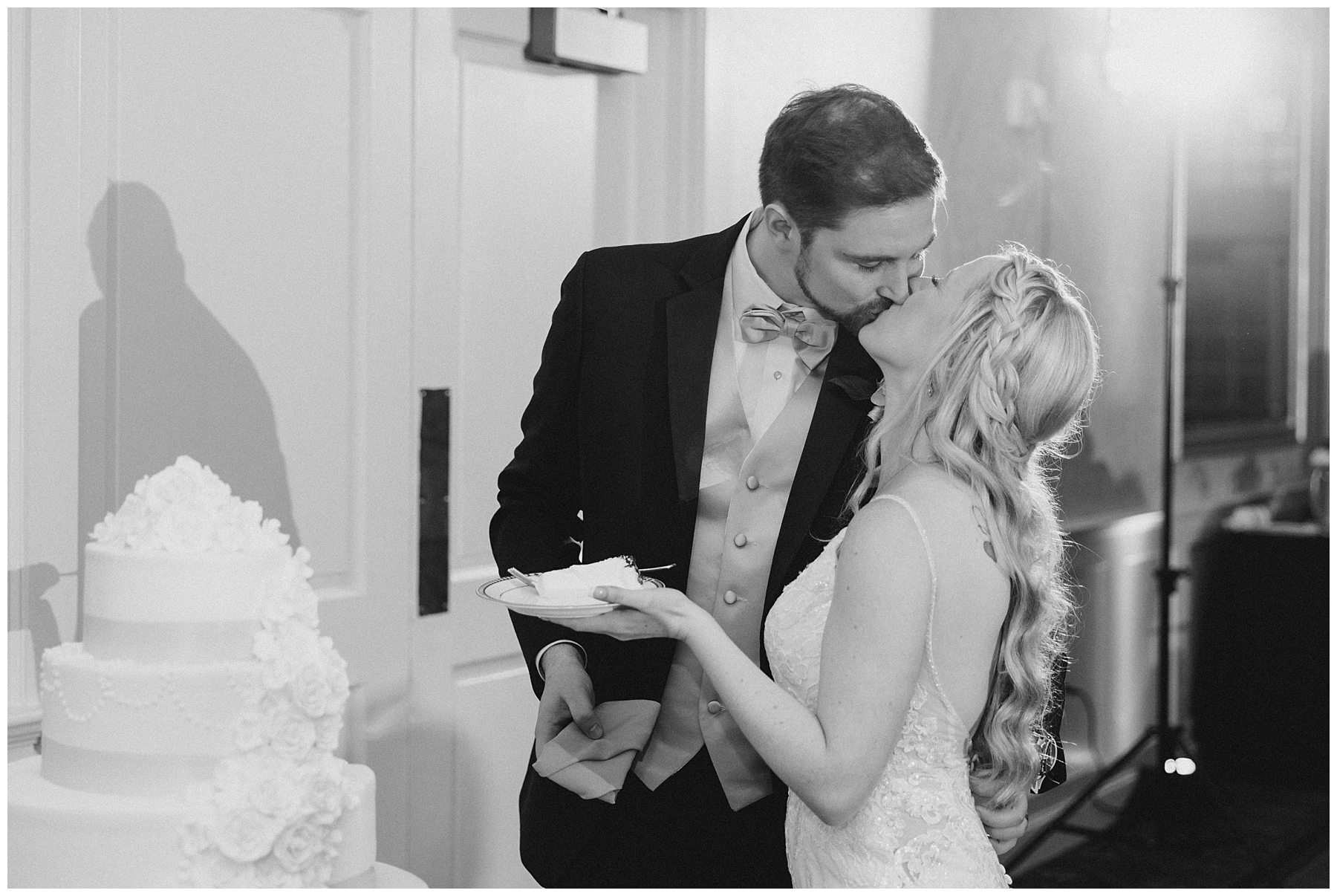 newlyweds share slice of wedding cake