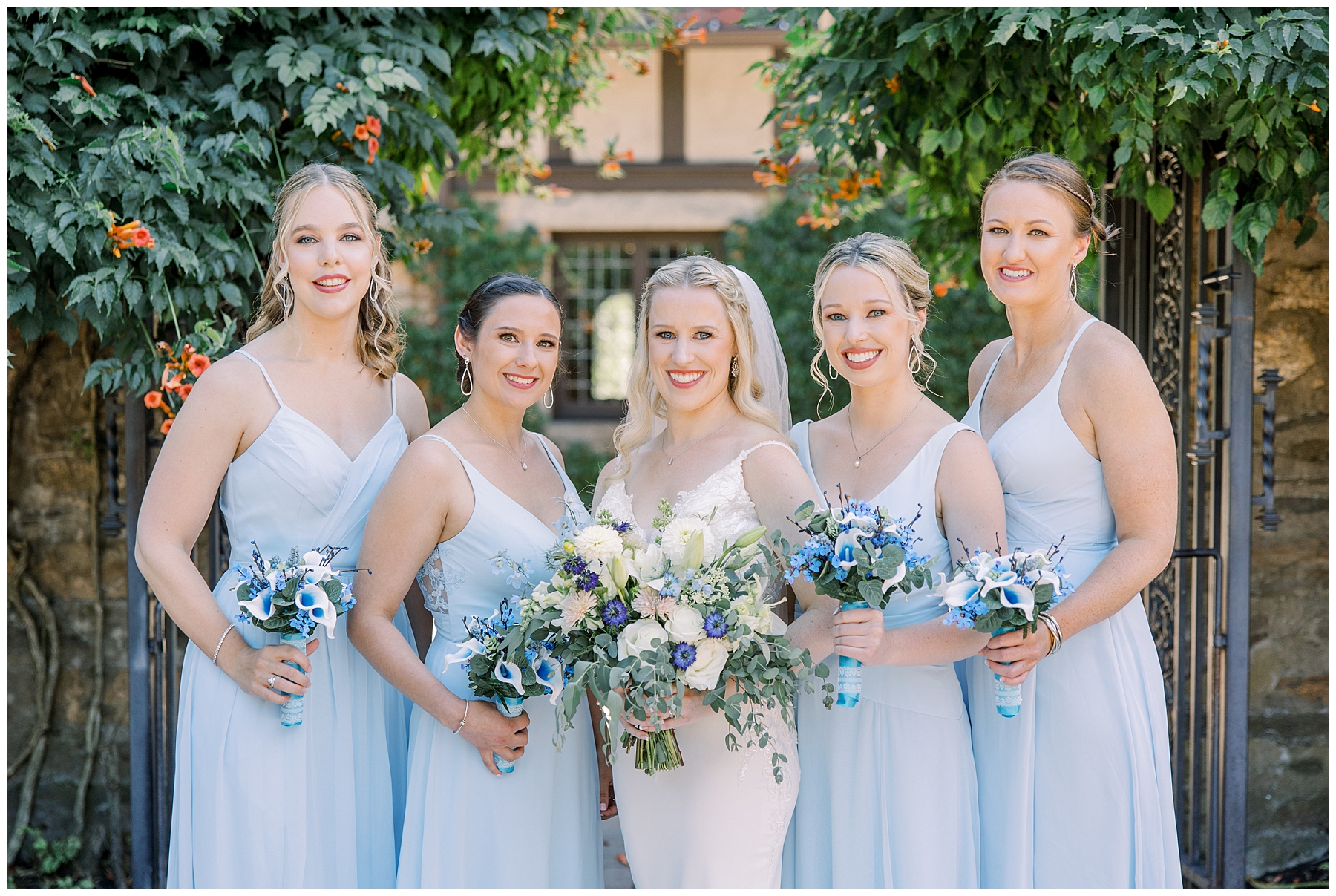 bride with bridesmaids in baby blue dresses