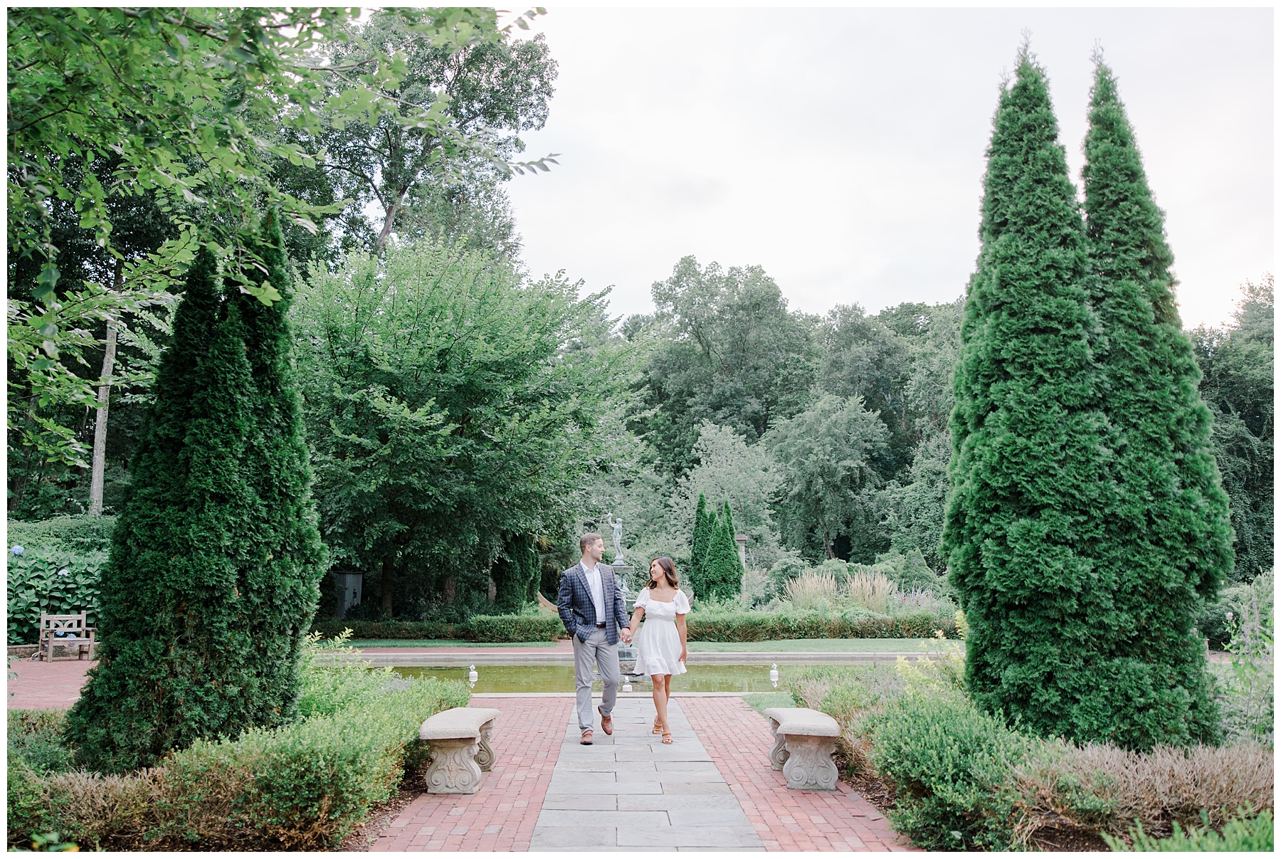 couple walk through garden during Romantic Boston Engagement Session