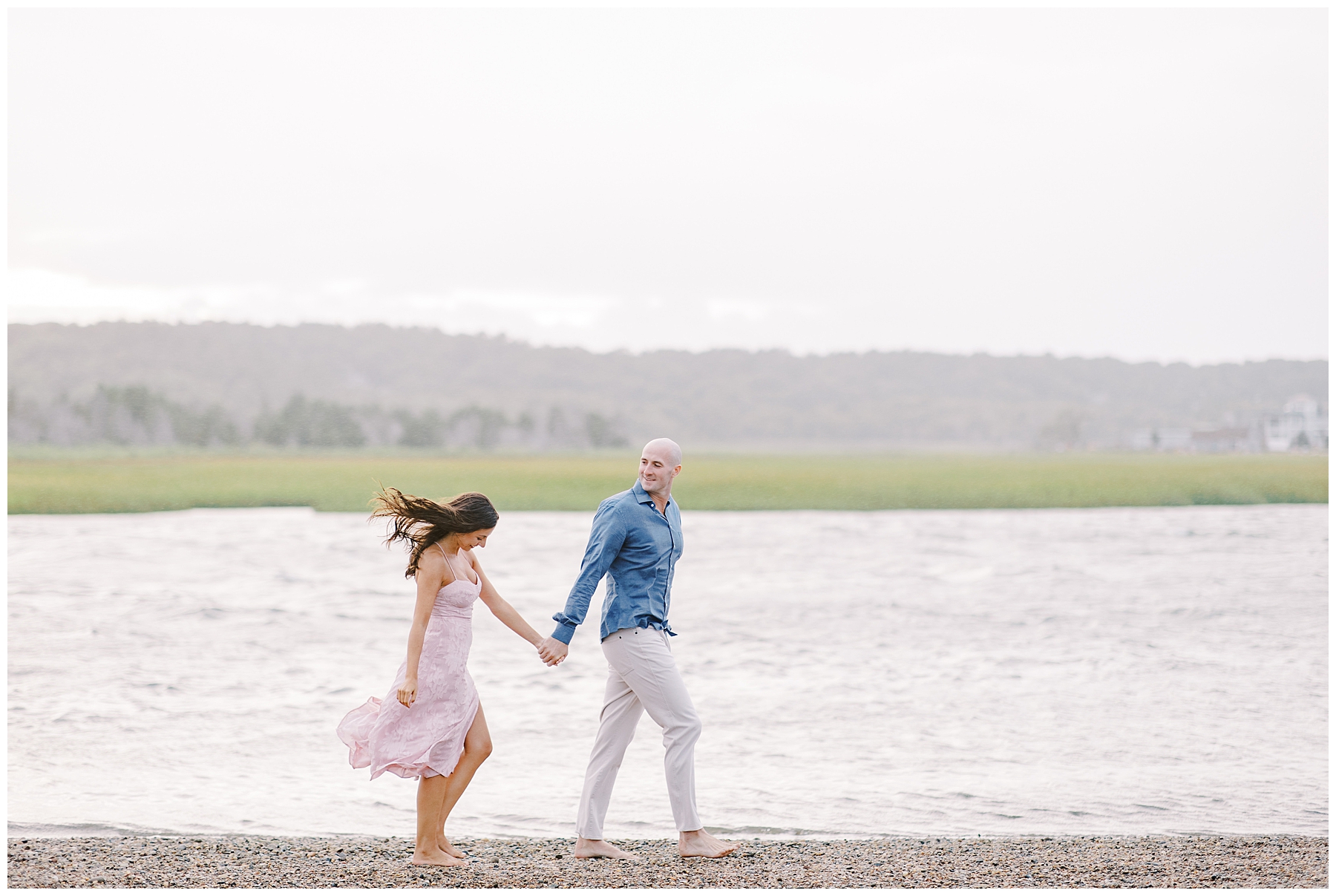 couple walk together holding hands during Marshfield MA Beach Engagement Session