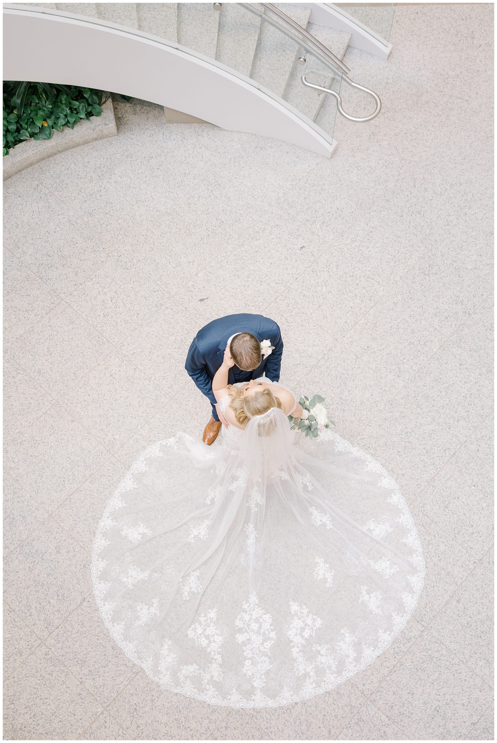 aerial portrait of bride and groom kissing 