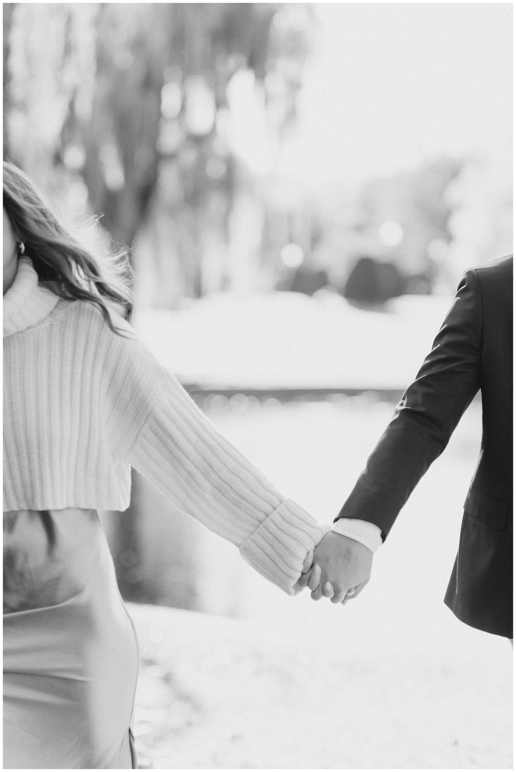 couple holding hands during engagement photos 
