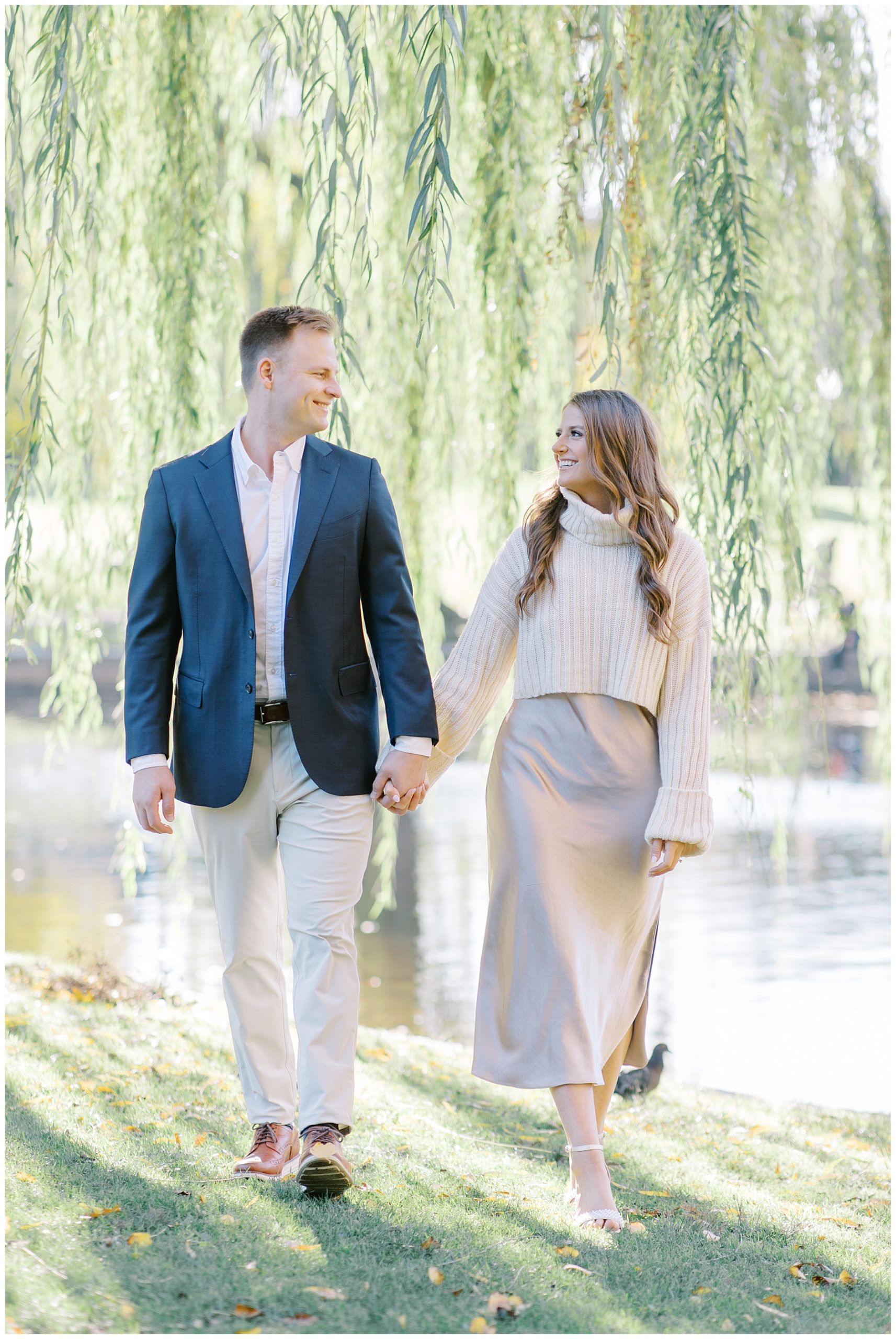 couple walk together holding hands through Boston Garden