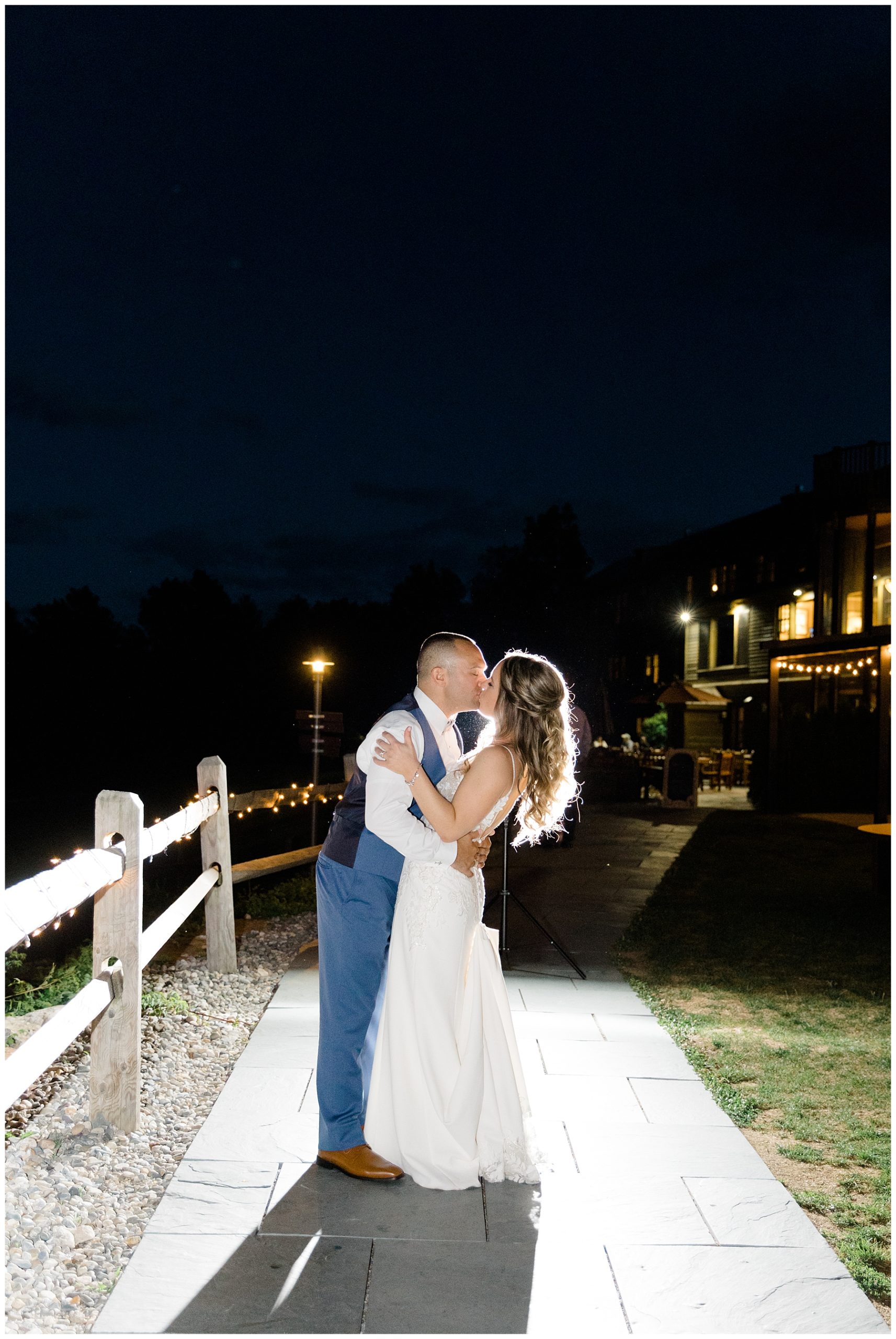 newlyweds kiss outside at the end of their wedding night