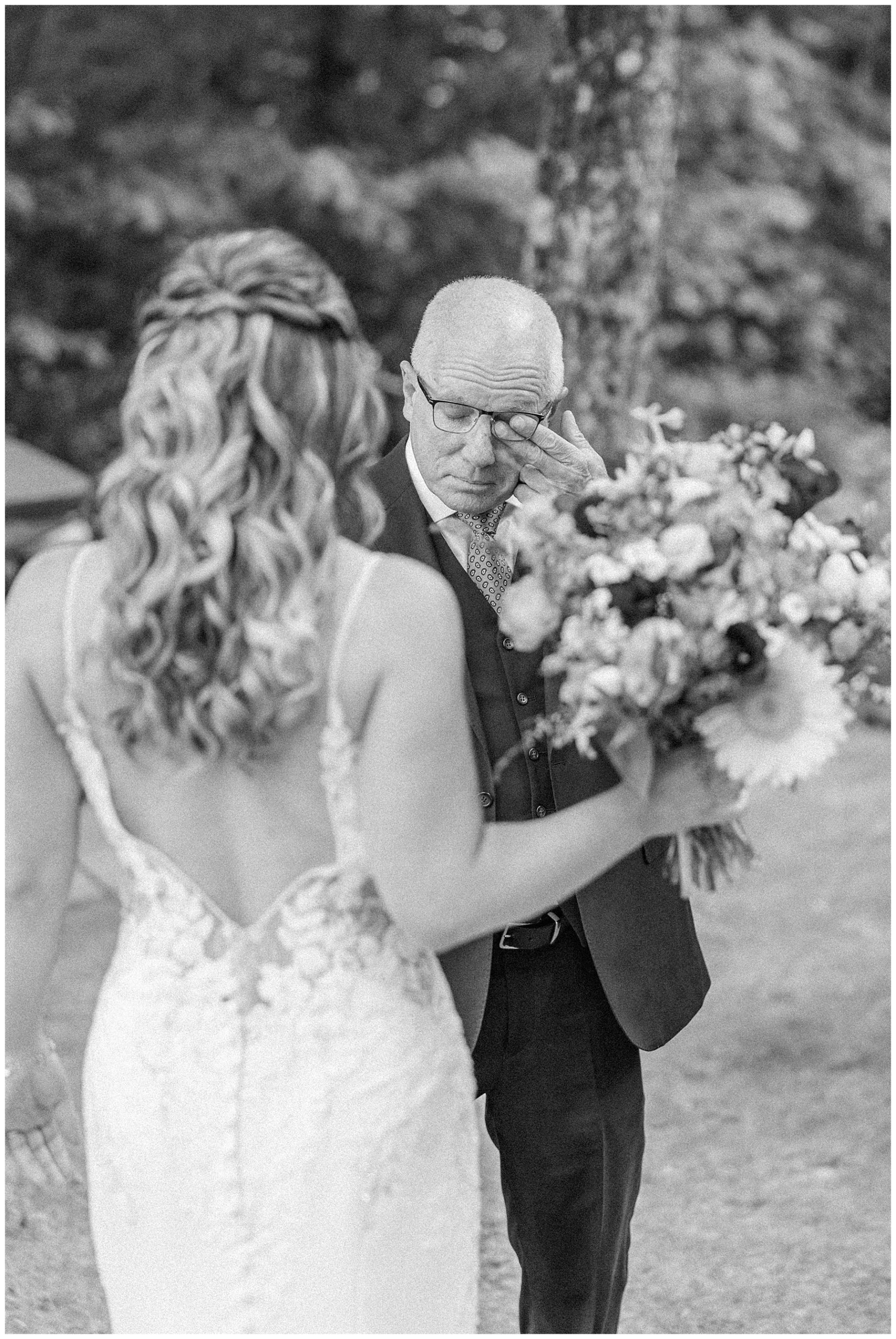 dad wipes away tears seeing his daughter on wedding day