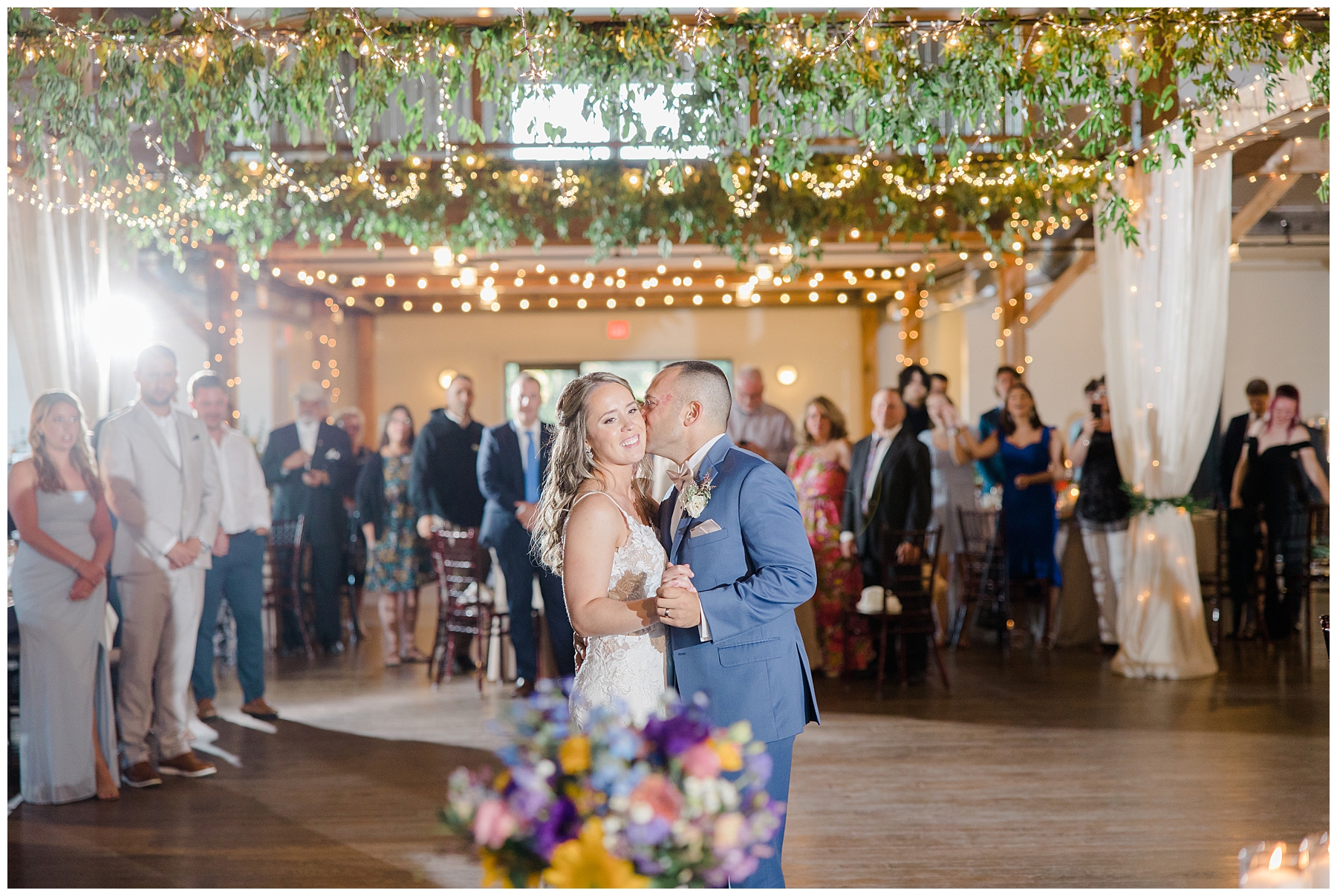 groom kisses his bride on the dance floor during dreamy vermont wedding