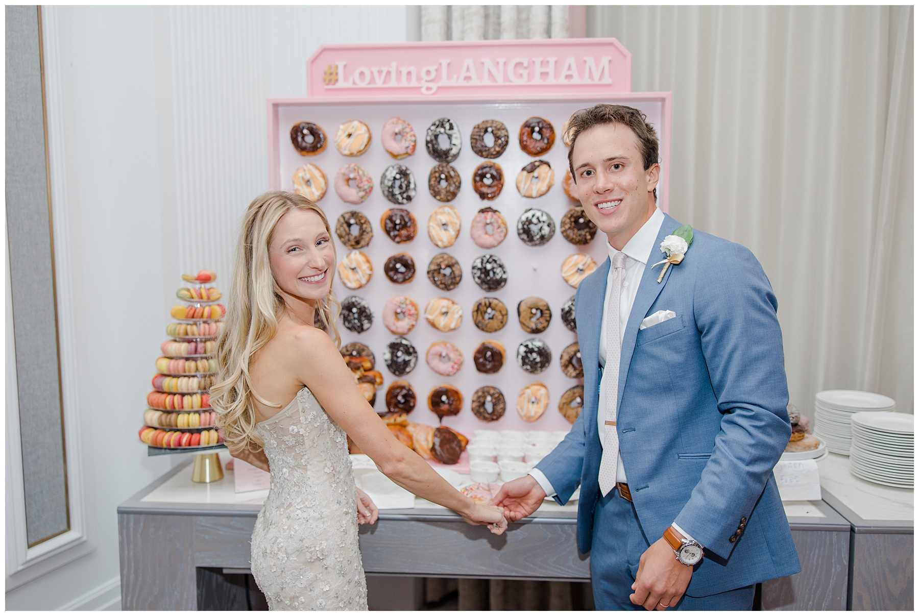 bride and groom in front of donut dessert table 