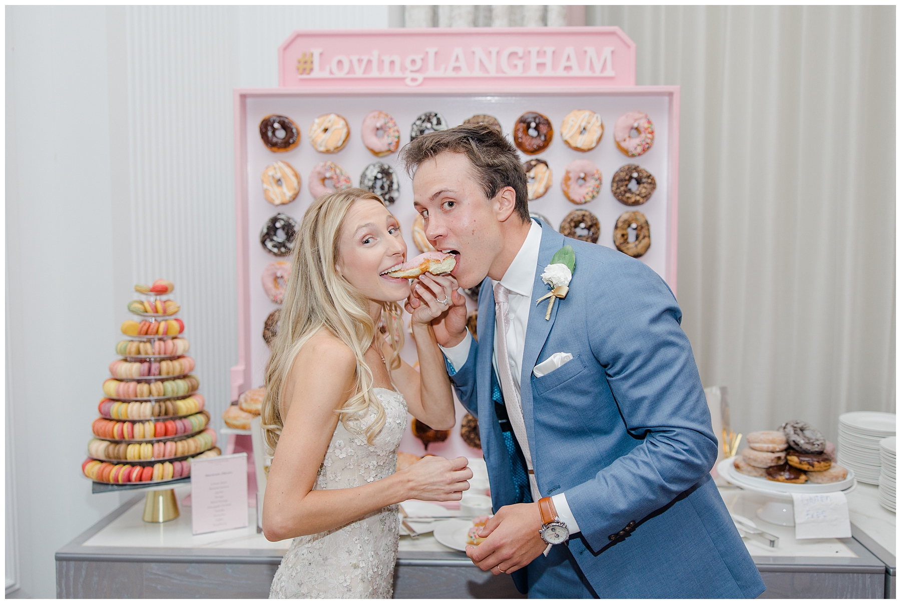 bride and groom feed each other donuts at wedding