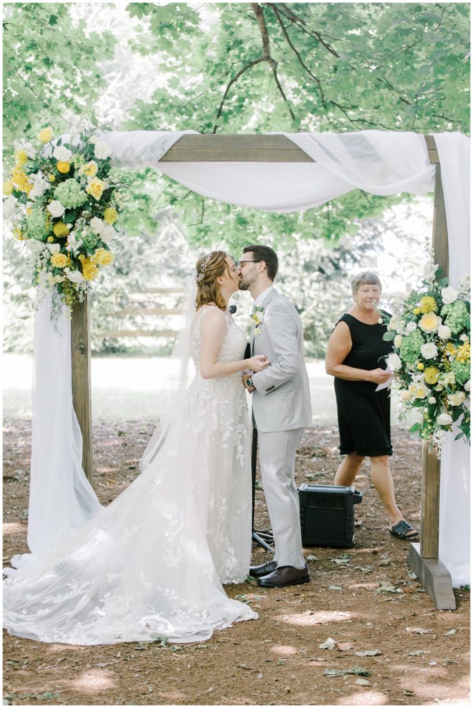 couple kiss at wedding ceremony