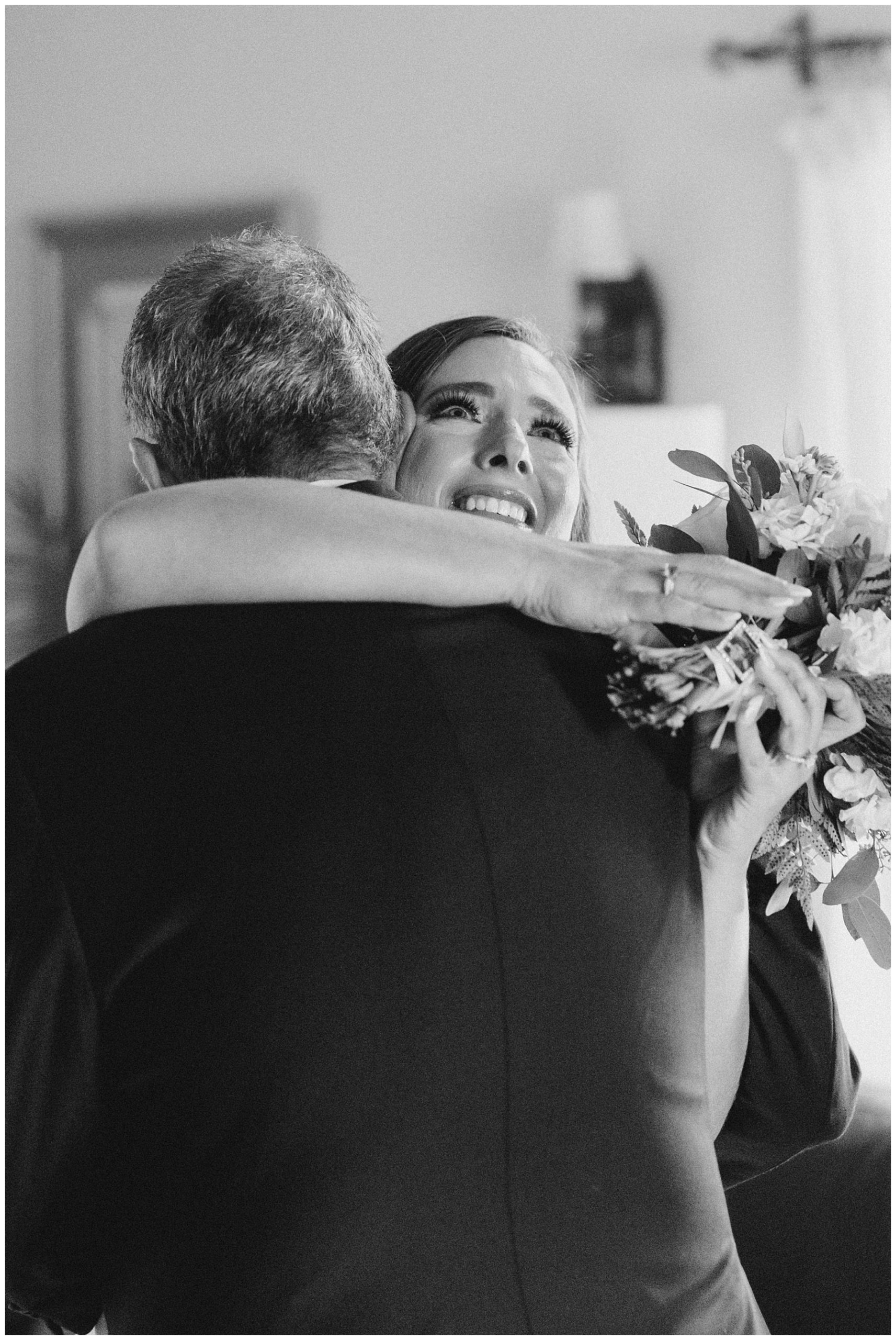 bride and father hug