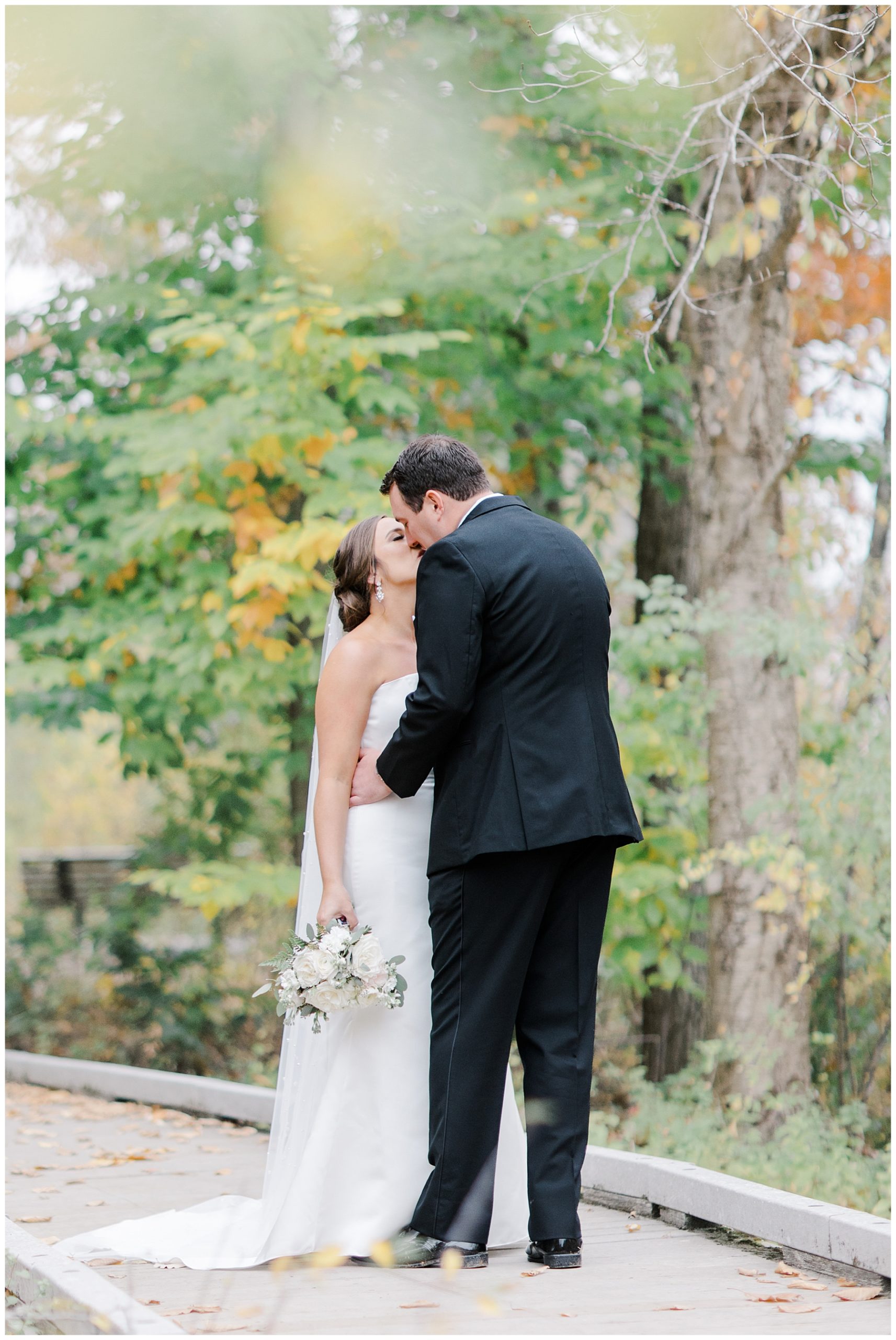couple kiss during first look before Willowdale Estate Fall Wedding 