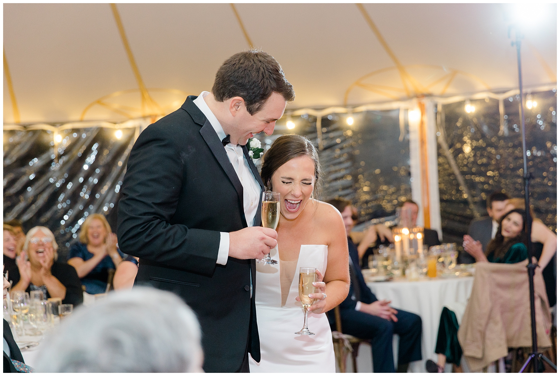 couple. laugh during wedding speeches