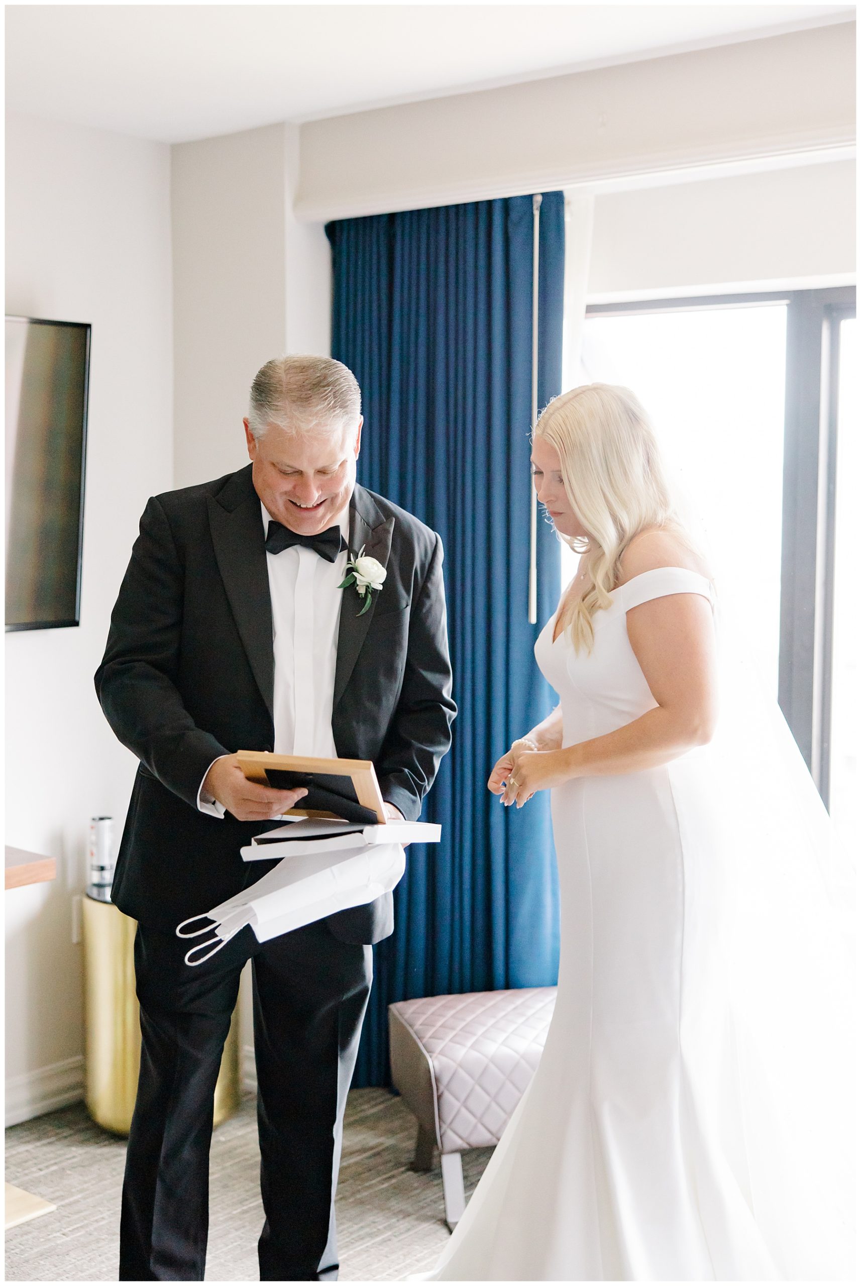 bride gives father a gift before wedding ceremony