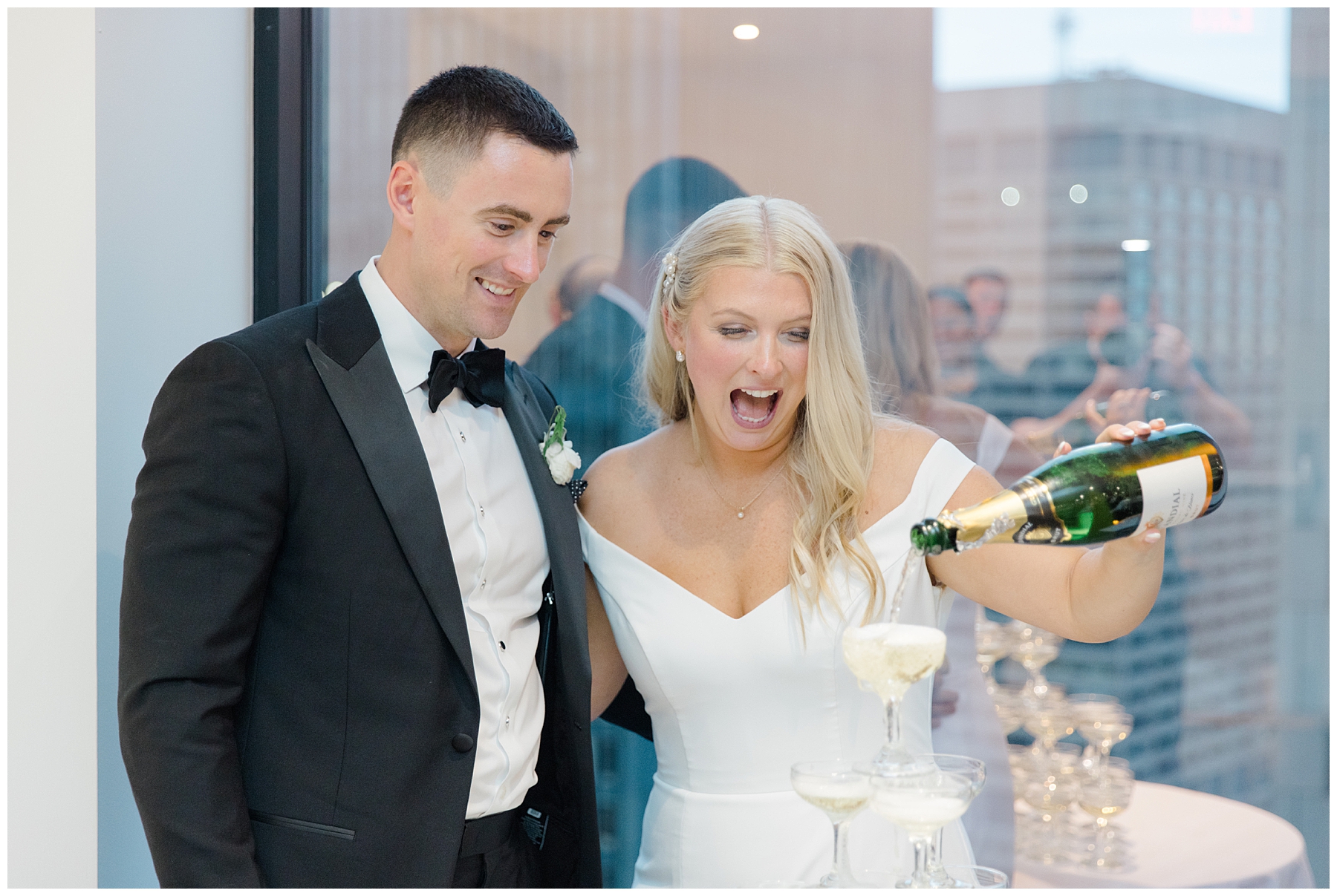 bride pours champagne on tower
