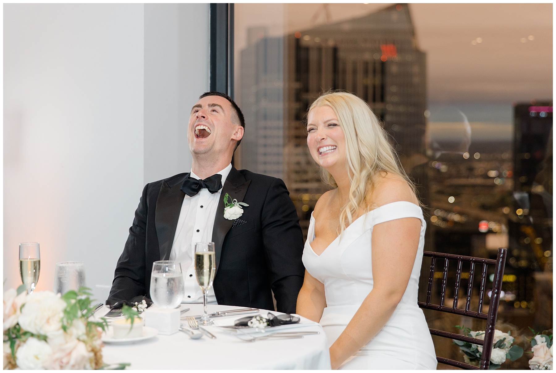 couple laugh during wedding toasts 